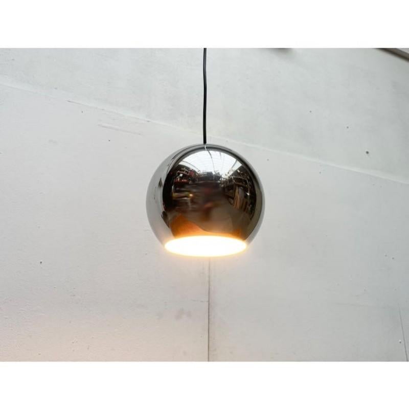 Two space age ball pendant lights made of aluminum.

A simple design with a special surface. The lamp body consists of a simple aluminum ball. The light comes out through an opening on the bottom. The outside of the lamp is highly polished. The