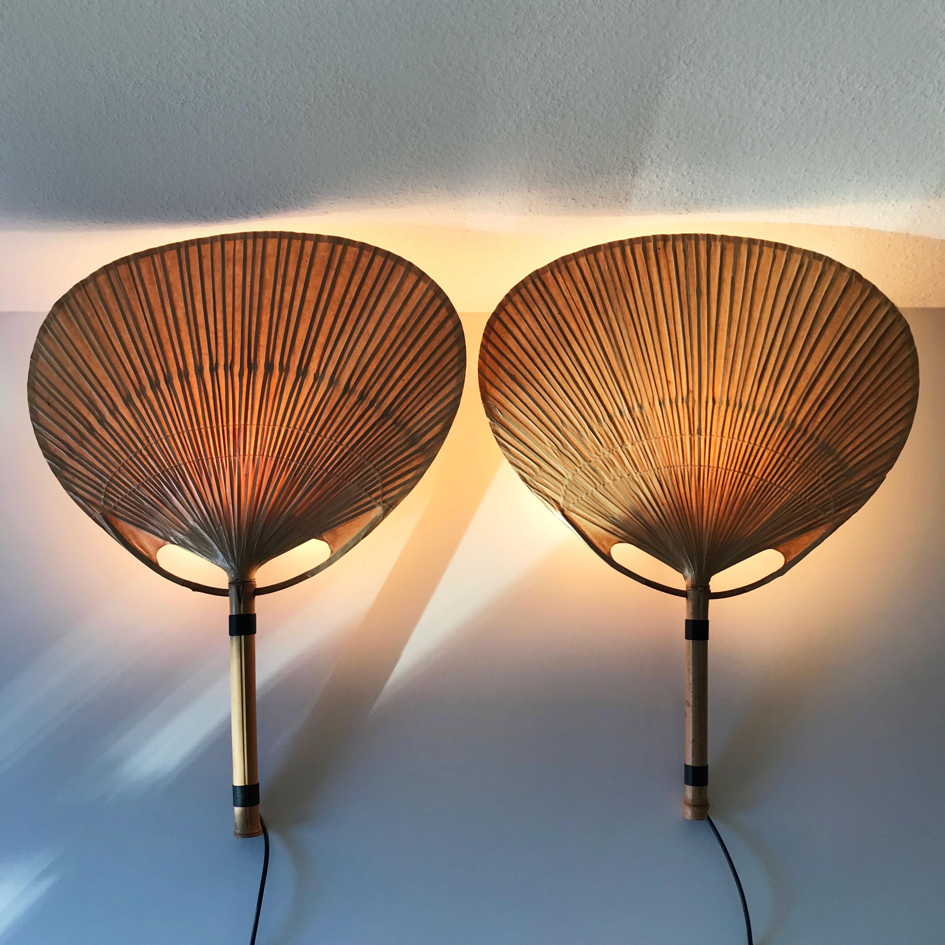 Set of two Mid-Century Modern 'Uchiwa' bamboo fan wall lamps / sconces lamp by Ingo Maurer for Design M, 1970s, Germany.

Executed in bamboo and rice paper. Each lamp needs 1 x E27 Edison screw fit bulbs. Delivery without bulbs. It runs both on