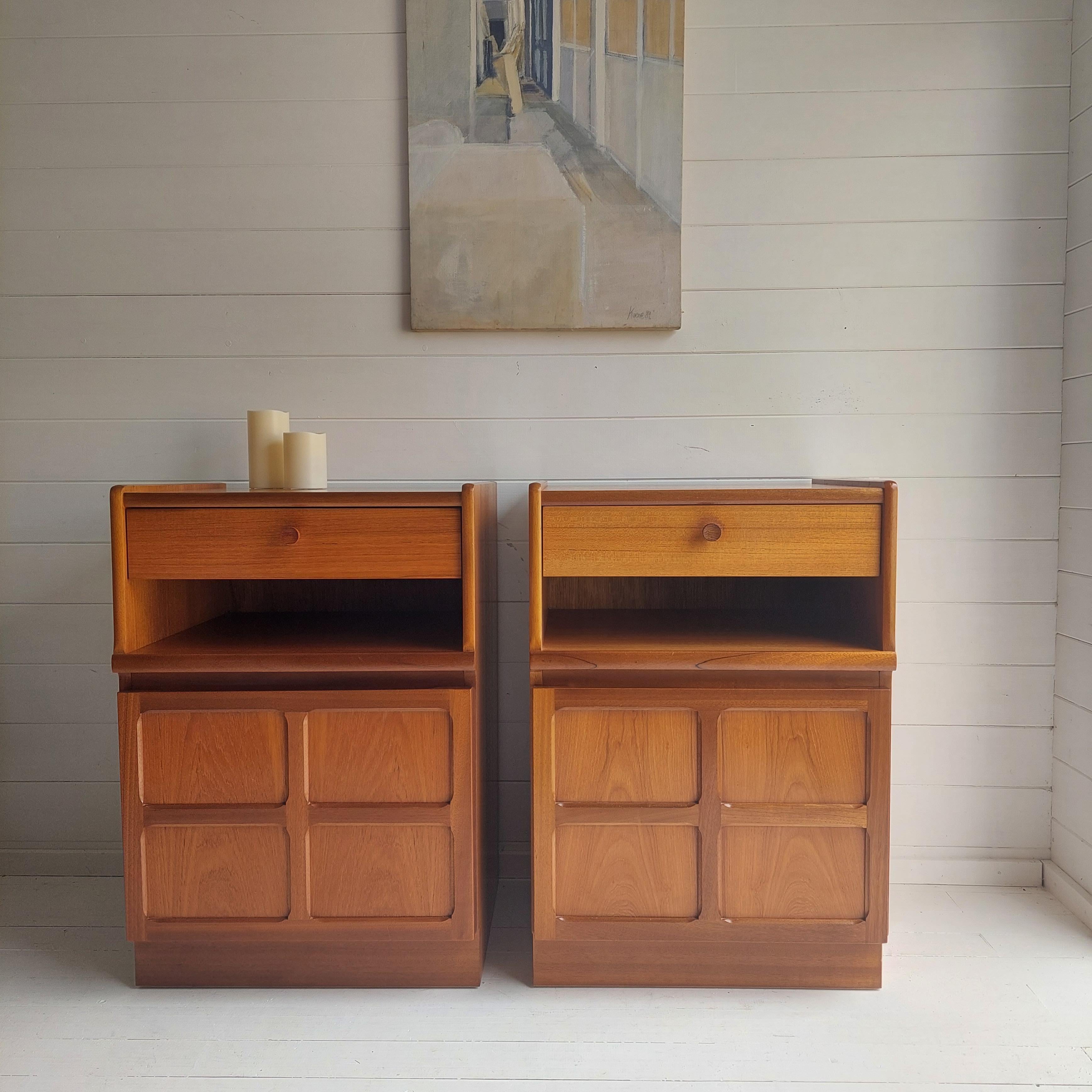 A great 1970s Nathan teak bedside tables.
Pair of bedside cabinets manufactured in the UK by Nathan, Parker Knoll.

They have a single drawer at the top that all slide well, underneath there is a shelf and there is a handy cupboard bellow.
The