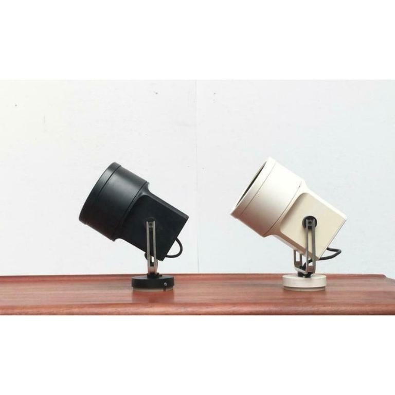 Poulsen Unispot wall or ceiling light in white and black. This piece has an attribution mark, Up to 250V (Europe/UK Standard). The wiring of this item may be original and might need replacement, if not specified otherwise.

Additional