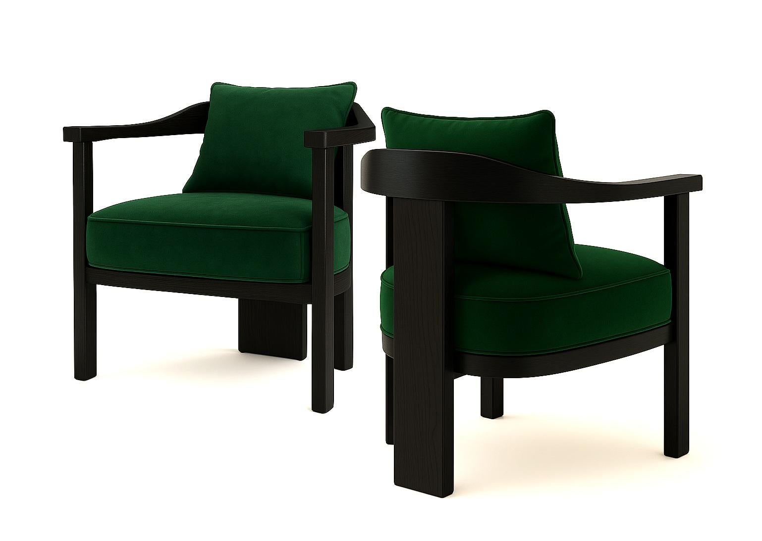 An exercise in sculptural restraint, this armchair features a solid wood frame with softly contoured edges and a curved backrest that cradles the sitter. The architectural silhouette is grounded by a generously upholstered seat cushion, offering