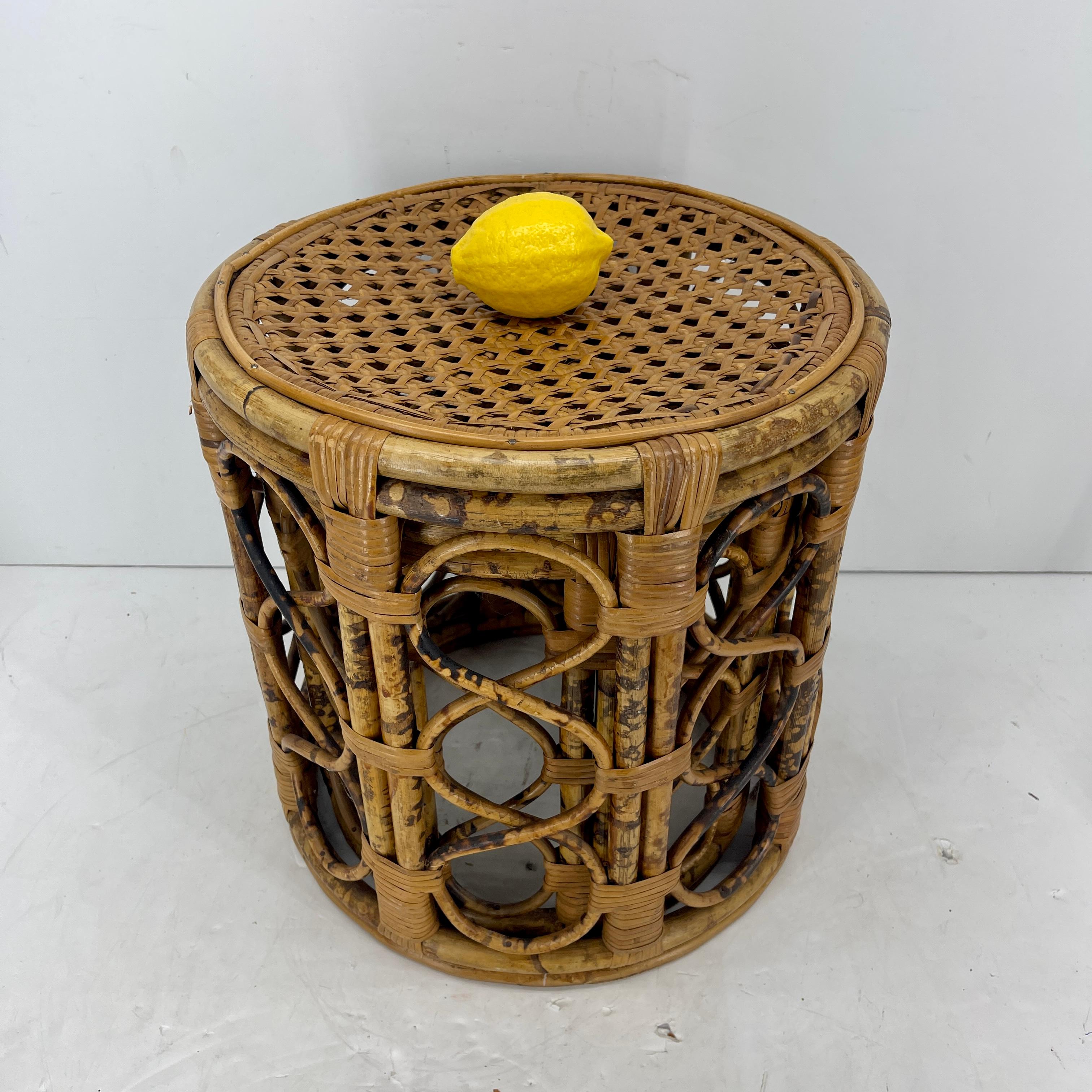 Mid 20th Century Burnt Bamboo Tortoise Rattan Round Nesting Tables, American circa 1950-60's. 
This set of nesting tables or end tables feature caned table tops. We see these tables in a living room or bedroom setting. 
