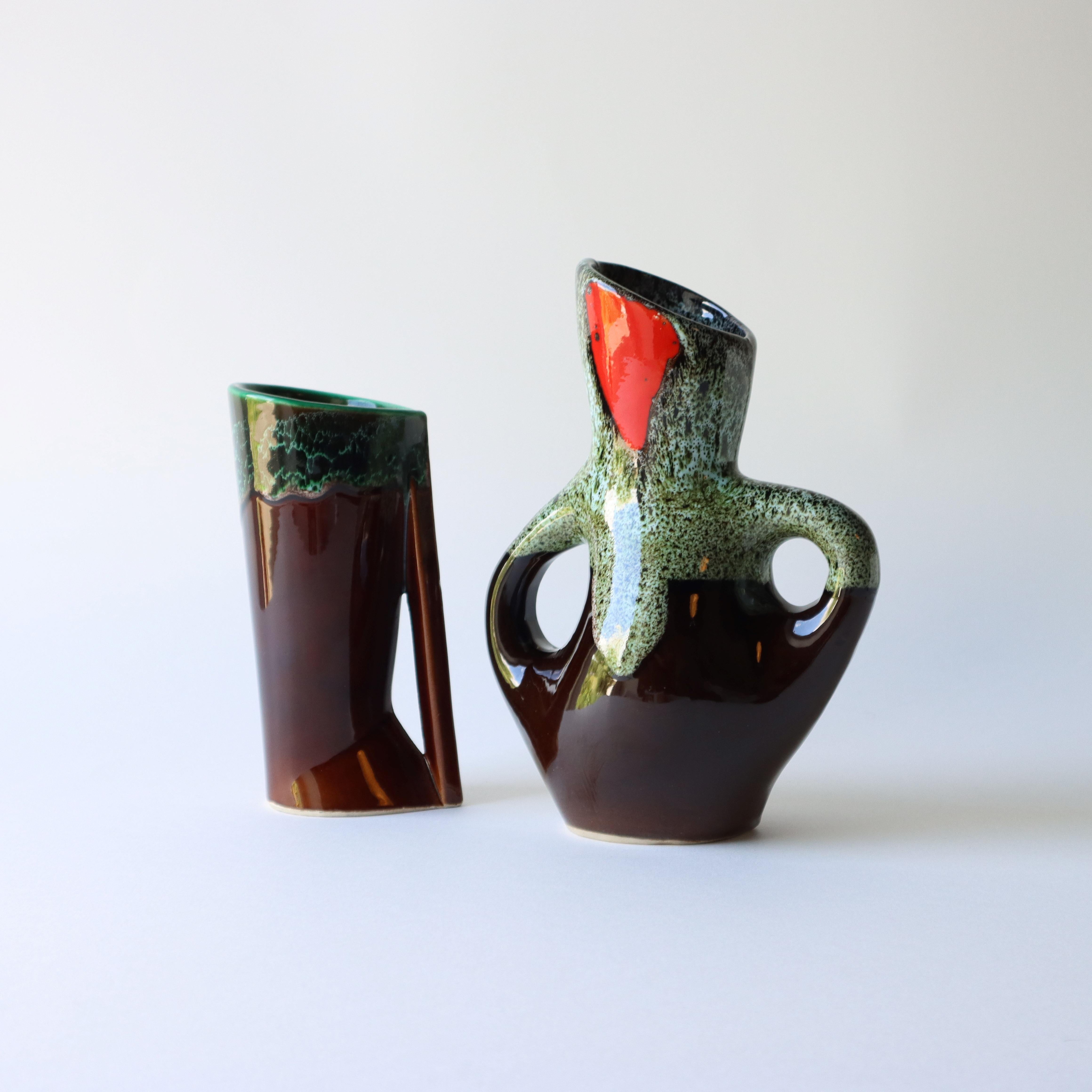 These beautiful Tree-Form Fat Lava Vases in glazed ceramic have pretty Curves and Angles
and the typical, vibrant Vallauris colors with drip effects (red, green and a touch of white) on a dark brown background.
The two different styles are a perfect
