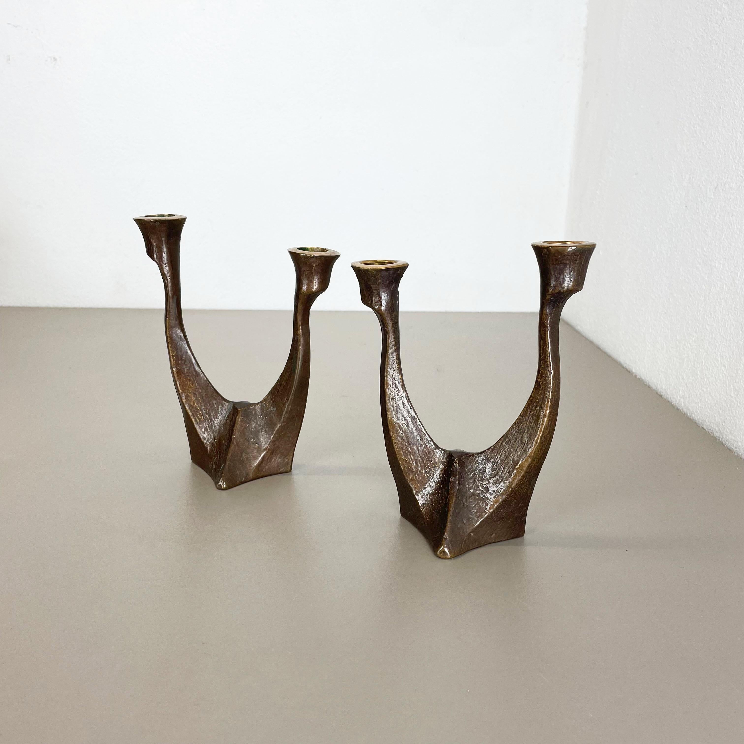 Article: Brutalist candleholder, set of 2

Origin: Germany

Design producer: Michael Harjes

Material: bronze

Decade: 1960s

Description: This original vintage candleholder set, was produced in the 1960s in Germany. Designed and executed by Michael