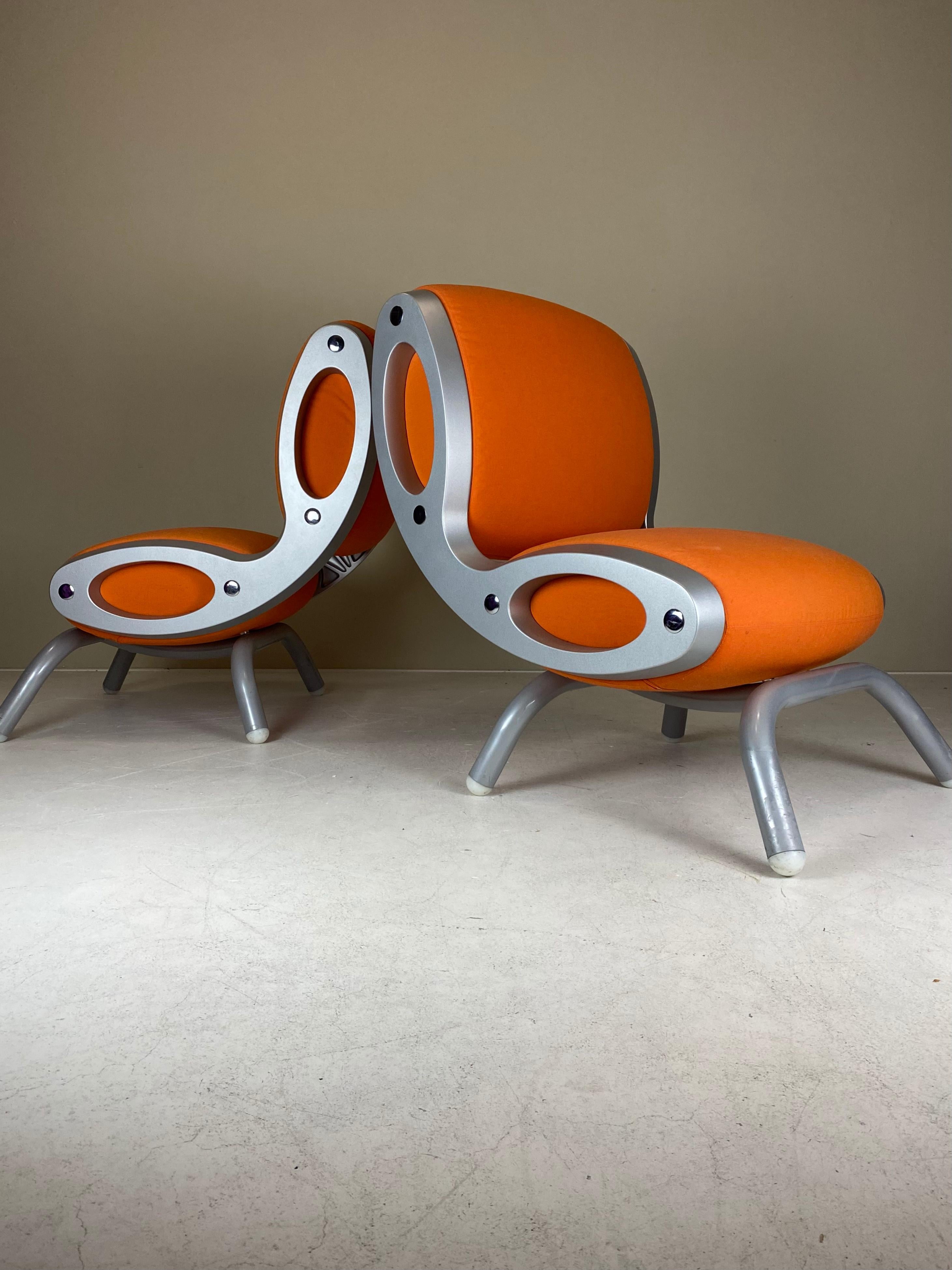 For sale is this lovely and rare set of two Gluon Chairs by Marc Newson, produced by Moroso in the ‘90s, and no longer in production today. 

The Gluon Chair was conceived as a modular chair that can be ‘glued‘ together to form longer sofas or