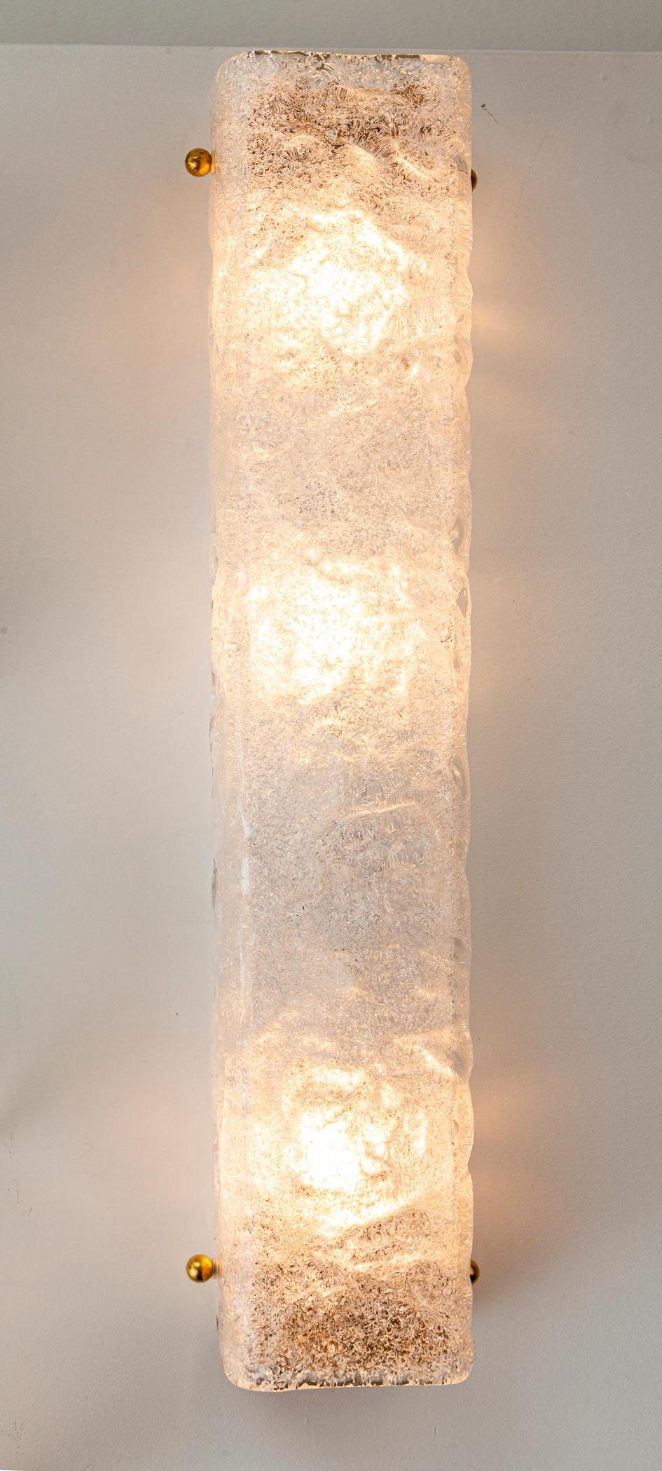 A lovely thickly textured rectangular glass shaped wall lights with brass hardware. This may be may be hung in either orientation. Note shimmery icy illumination.  

Sold as electrified to code with three E26 sockets , UL certification