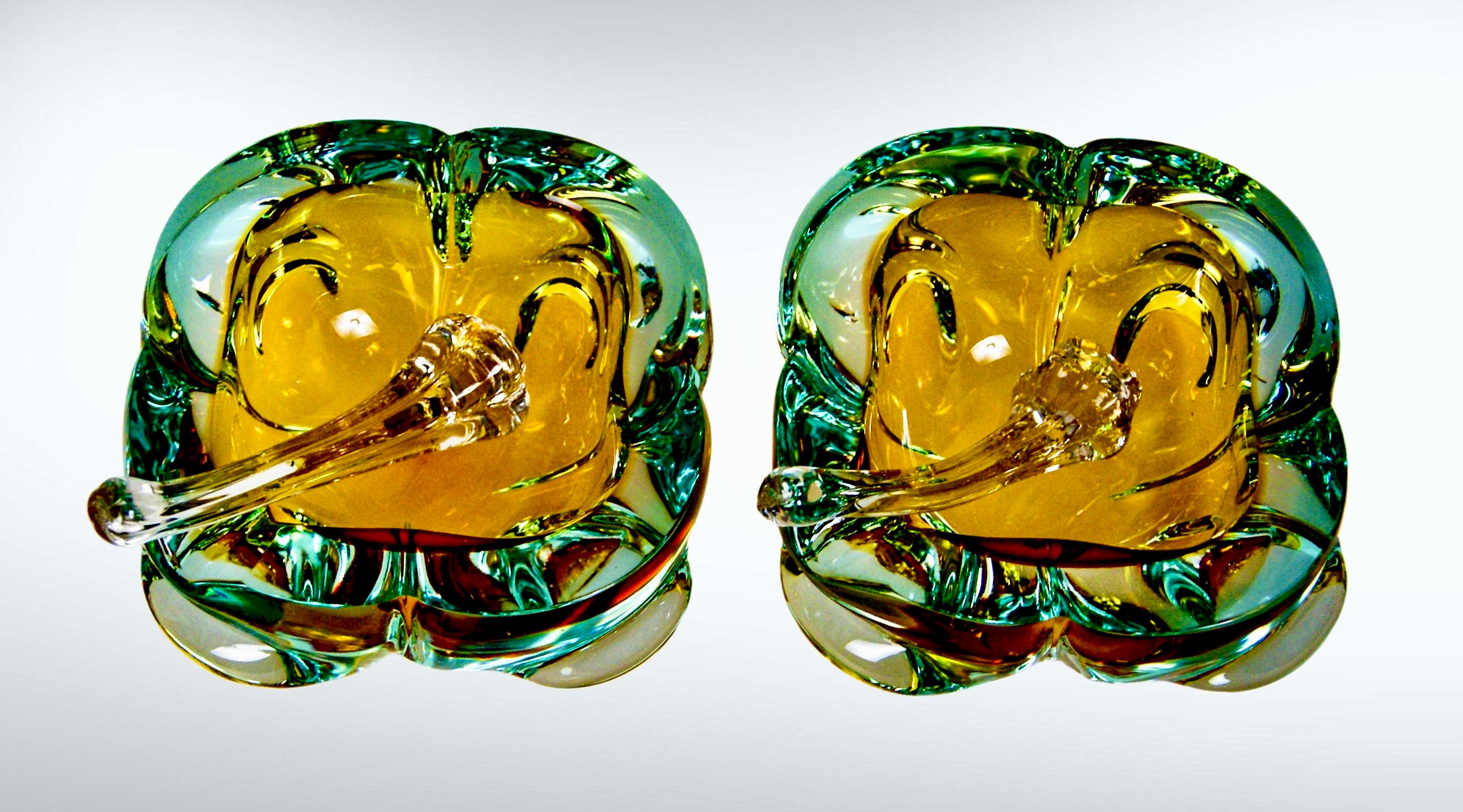 Pair of 2 Murano sommerso glass cigar ashtrays and accompanying stubbers.
Attributed to master glass artisan Flavio Poli, circa 1950s.
Chunky amber colored glass with a submerged aqua blue/green coloring.
The bowls each have 1 wide bridge/cigar