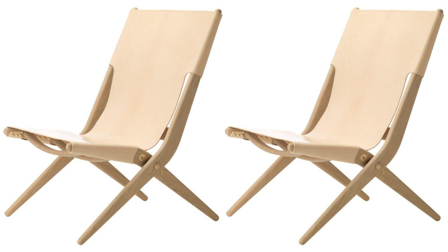 Set of 2 natural oak and natural leather saxe chairs by Lassen
Dimensions: W 60 x D 67 x H 84 cm 
Materials: leather, oak.

Mogens Lassen was perceived as ‘the naughty boy in class’, but he aimed for perfection in each design project. His eye