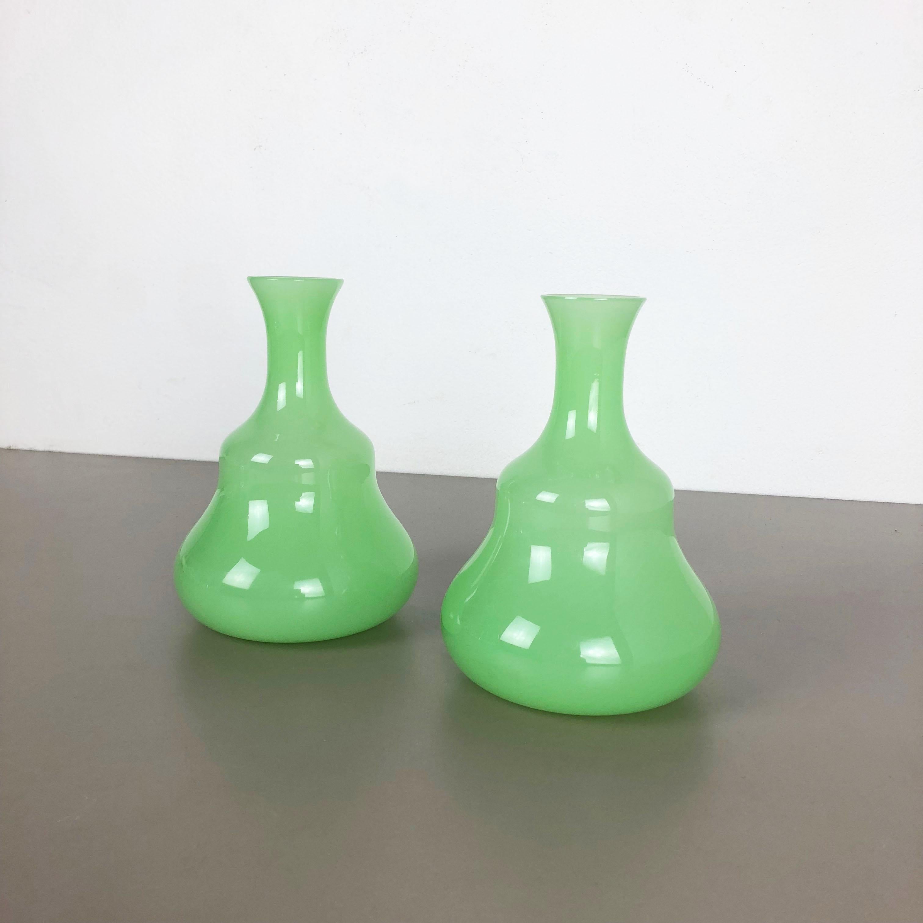 Article:

Murano opaline glass vases set of 2


Design:

Gino Cenedese


Producer:

Cenedese Vetri (marked underneath the vase)


Origin:

Murano, Italy


Decade:

1960s-1970s


This original set of 2 vase elements were