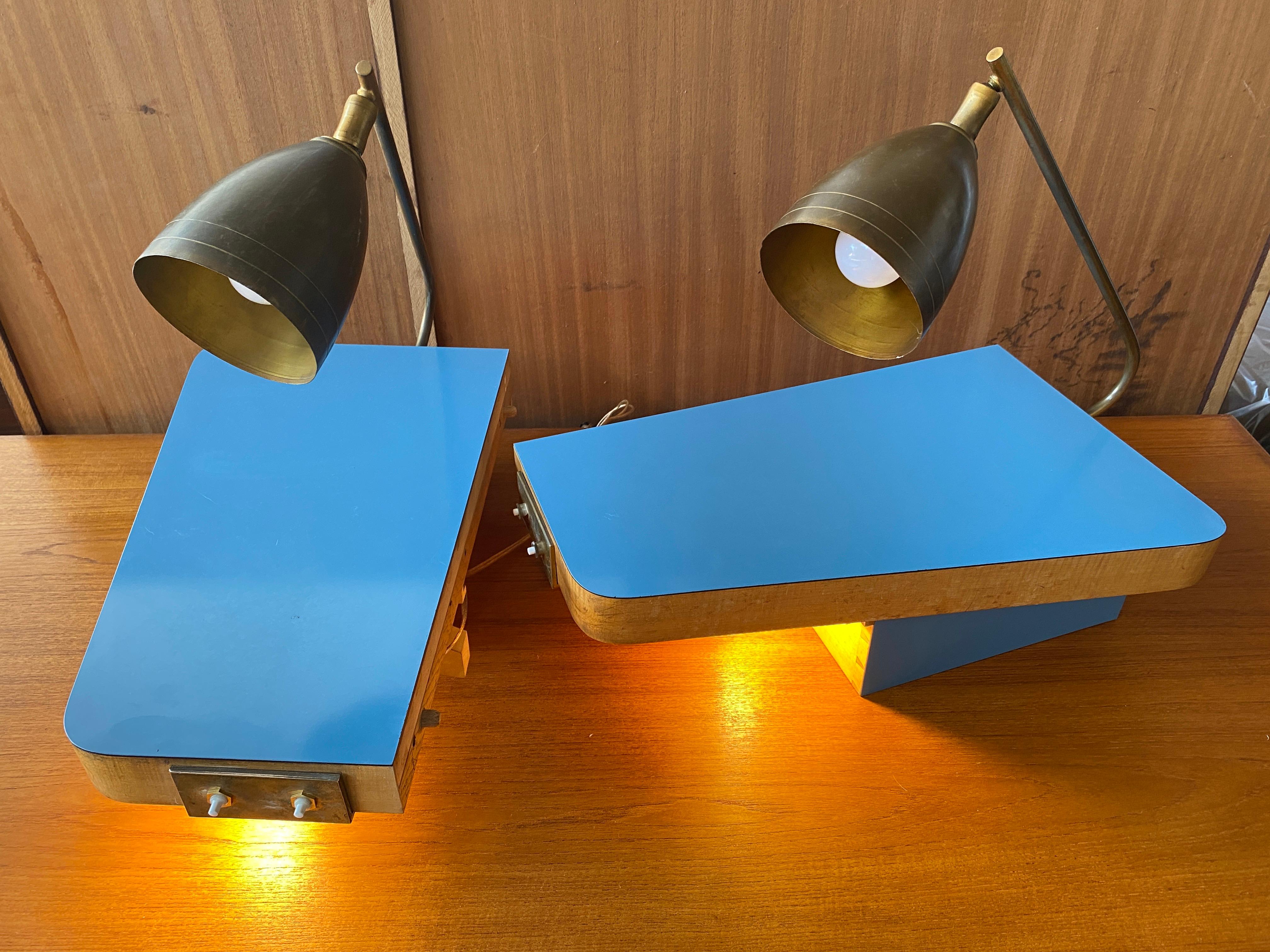 Set of 2 bedside tables with double lighting lamps, brass lamp and under the drawer. Facade and tray in blue formica Circa 1950. Lighting in working order.