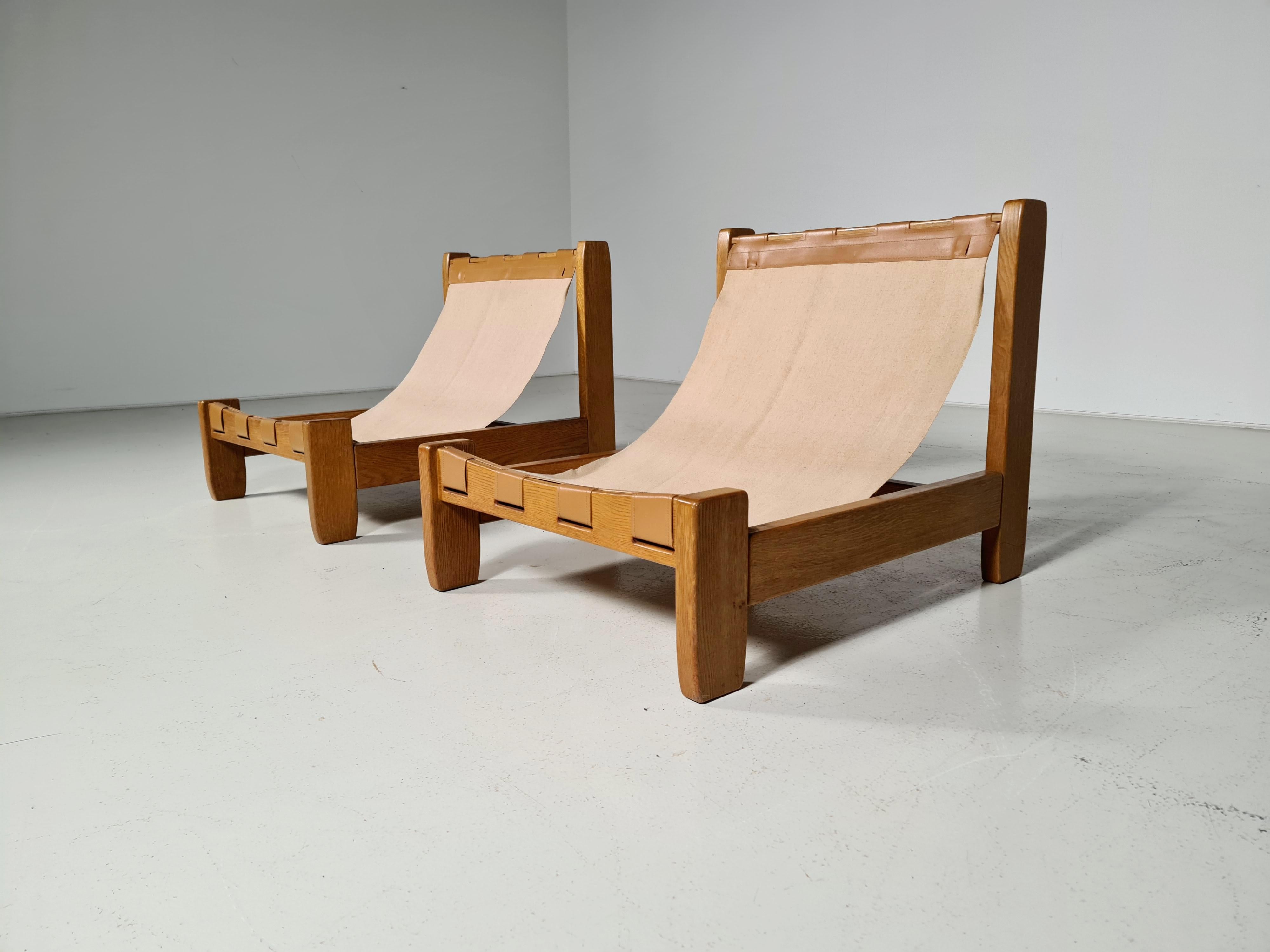 Rare set of oak sling chairs with the original canvas upholstery, the 1970s, France. The canvas seat is connected to the oak frame by a leather construction.