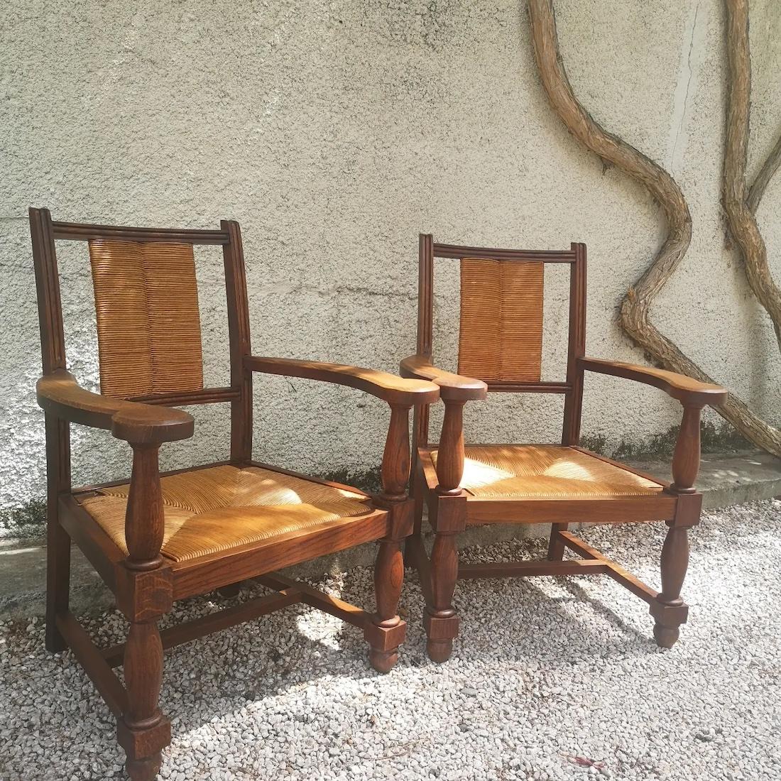 set of 2 oak armchairs and straw seat circa 1940 in the Charles Dudouyt and Victor Courtray style, good condition, some traces of proper use.
Charles Dudouyt 
The work of Charles Dudouyt, highly regarded by collectors and art deco furniture