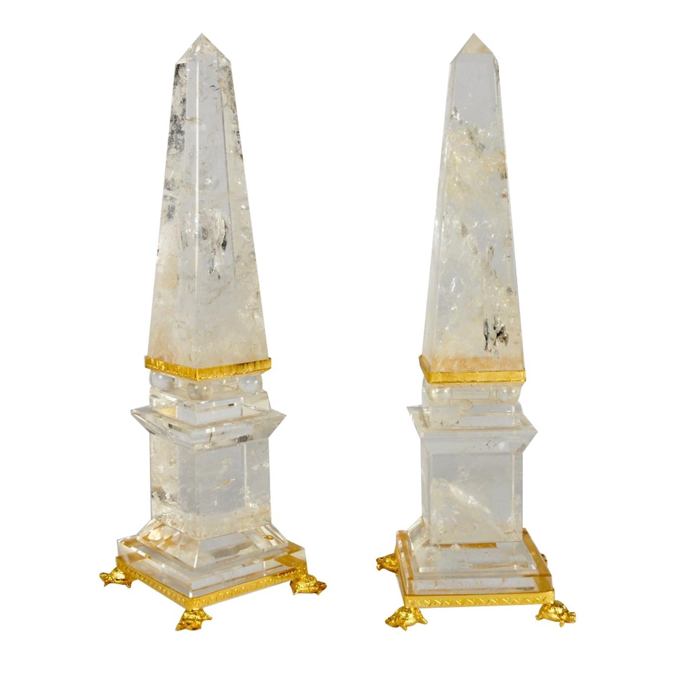 Making a lavish yet delicate statement wherever they are placed, these two decorative obelisks of prized crystal from Madagascar are entirely hand-worked to achieve their incredibly smooth surface. Their tapering silhouette rises from a footed