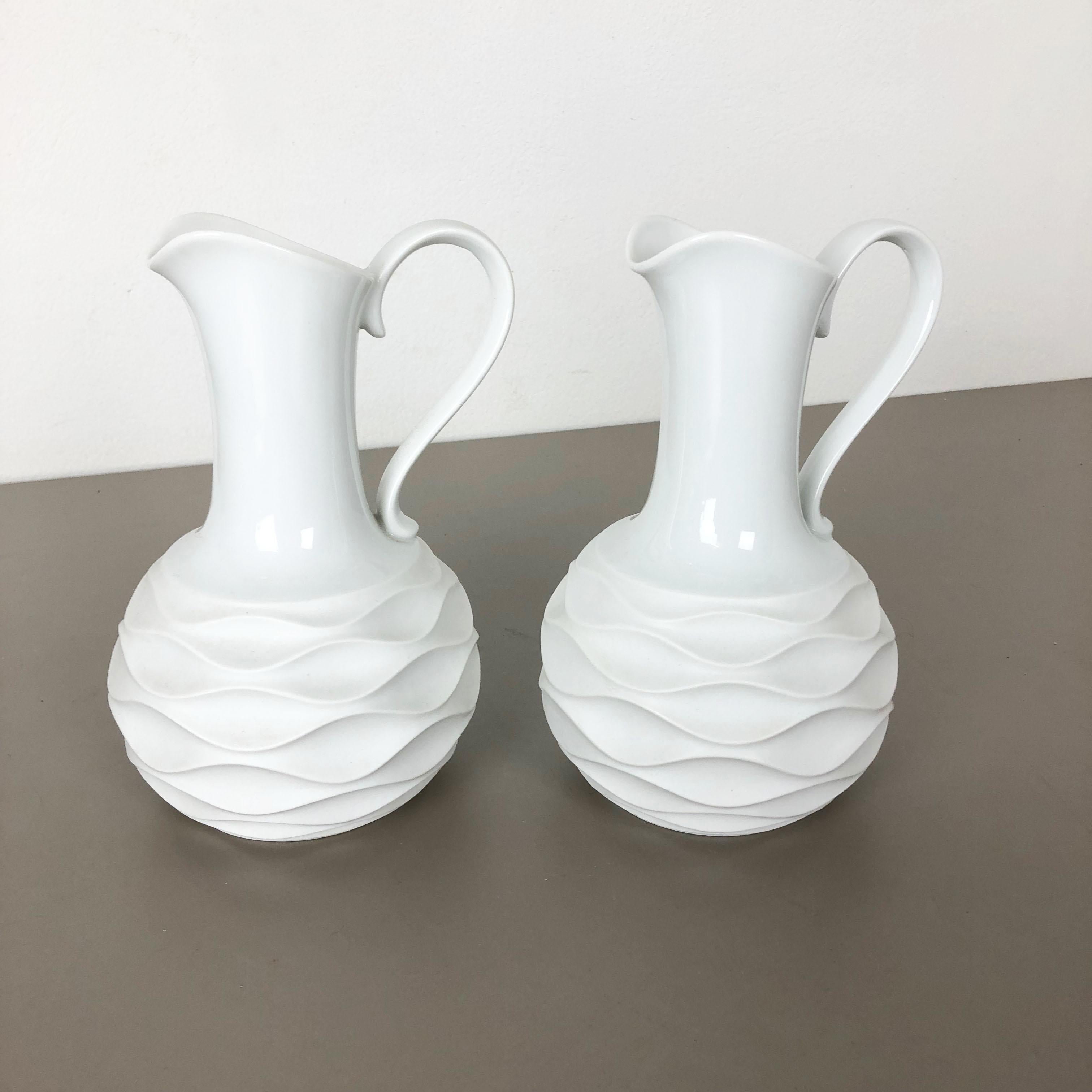 Article:

Op Art porcelain vases set of 2


Producer:

Edelstein Bavaria, Germany

Age:

1970s


This original vintage OP Art Vase set in jug form was produced in the 1970s in Germany. It is made of porcelain with an OP Art elliptical