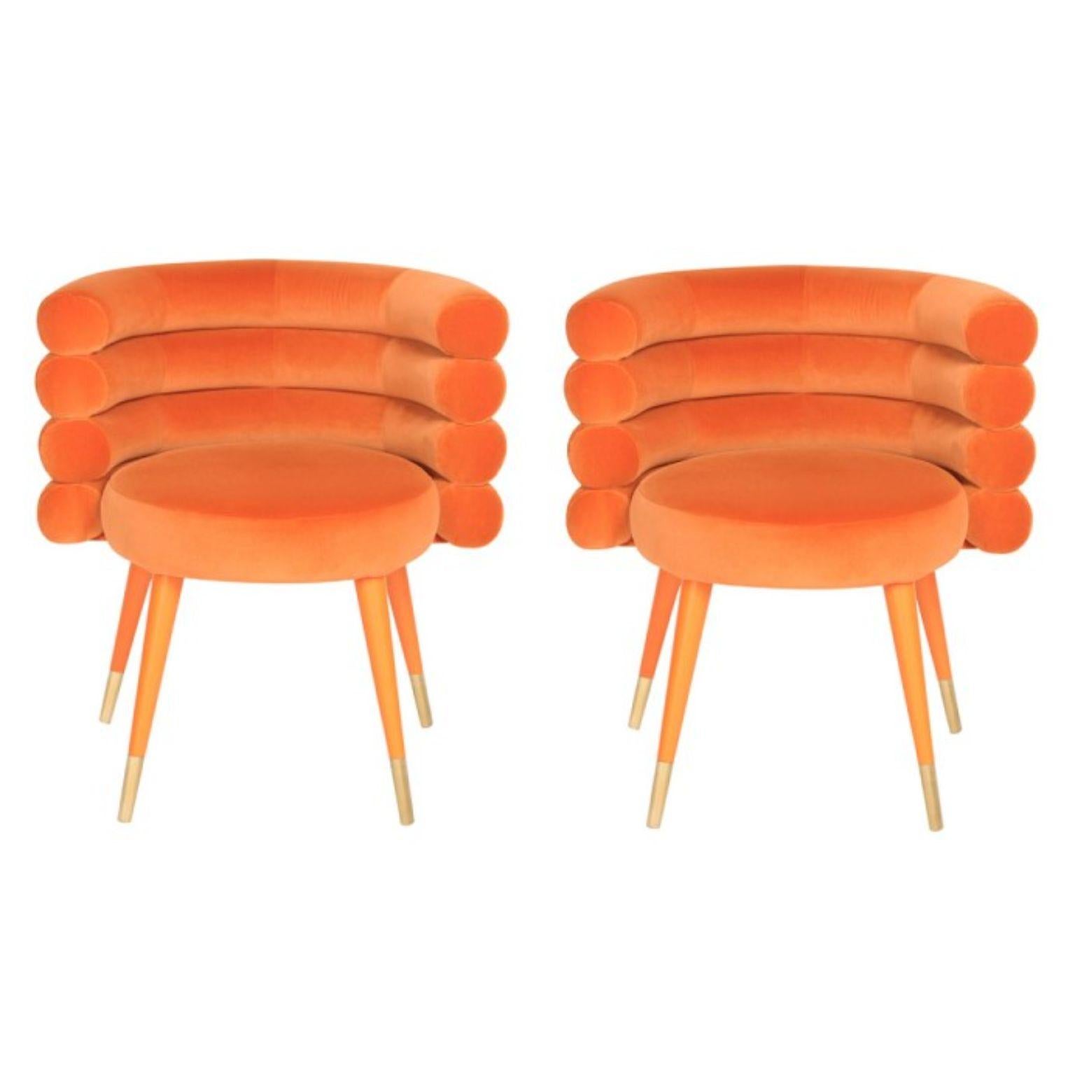 Set of 2 orange marshmallow dining chairs, Royal Stranger
Dimensions: 78 x 70 x 60 cm
Materials: velvet upholstery and brass
Available in: mint green, light pink, royal green and royal red

Royal Stranger is an exclusive furniture brand