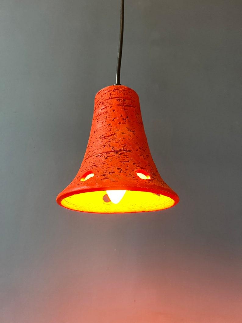 Dos lámparas colgantes de cerámica en forma de triángulo de color naranja. Las lámparas necesitan una bombilla E27/26 (estándar) cada una.

Más información:
Materiales: Cerámica, metal
Periodo: 1970s
Dimensiones:ø Pantallas: 15 cm
Altura tonos: 19