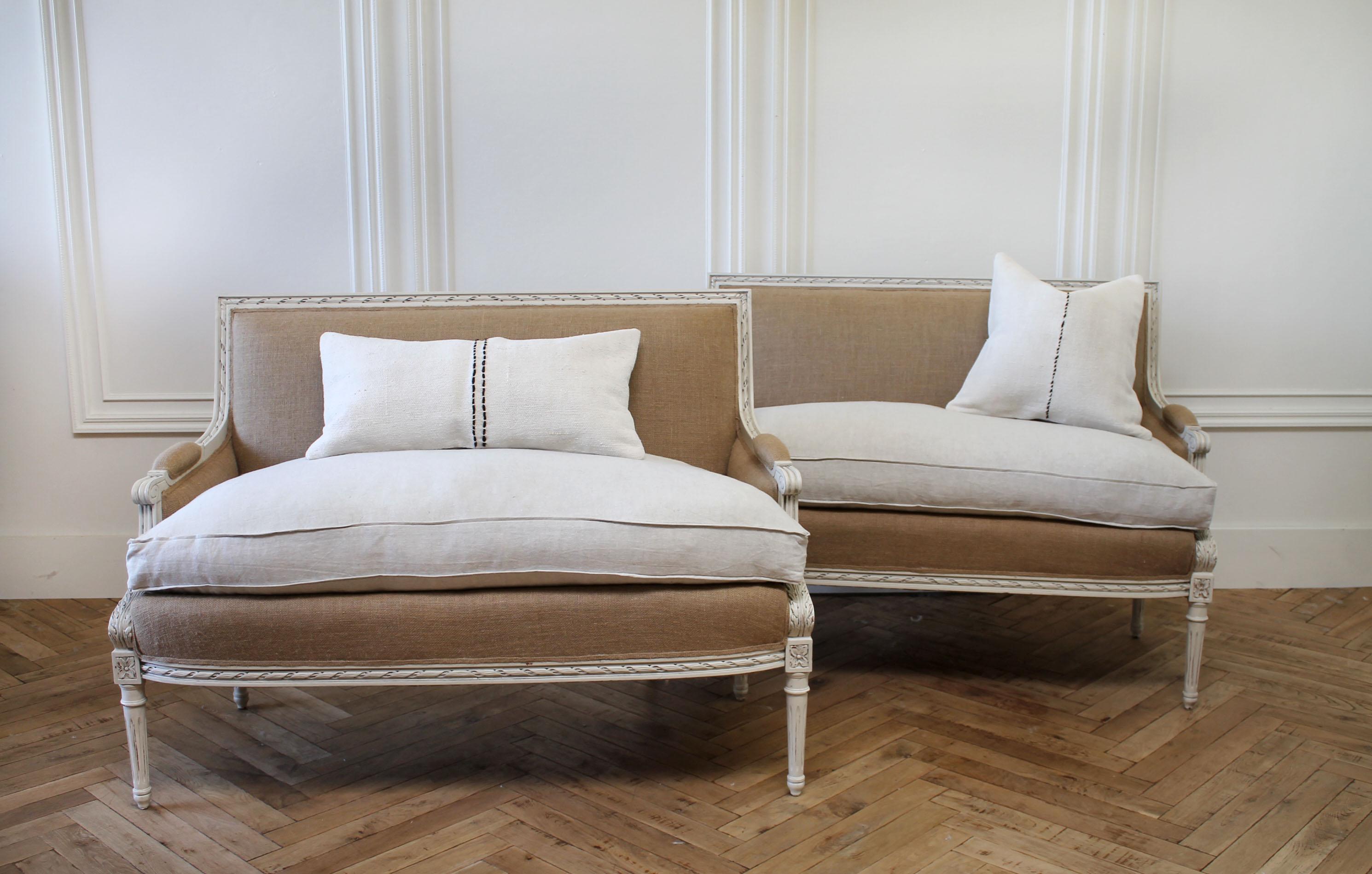 Matching painted and upholstered vintage Louis XVI style settees
Painted in oyster white finish with subtle distressed edges, and antique patina. A linen slip covered cushion in natural, over a down wrapped seat.
Can be machine washed if