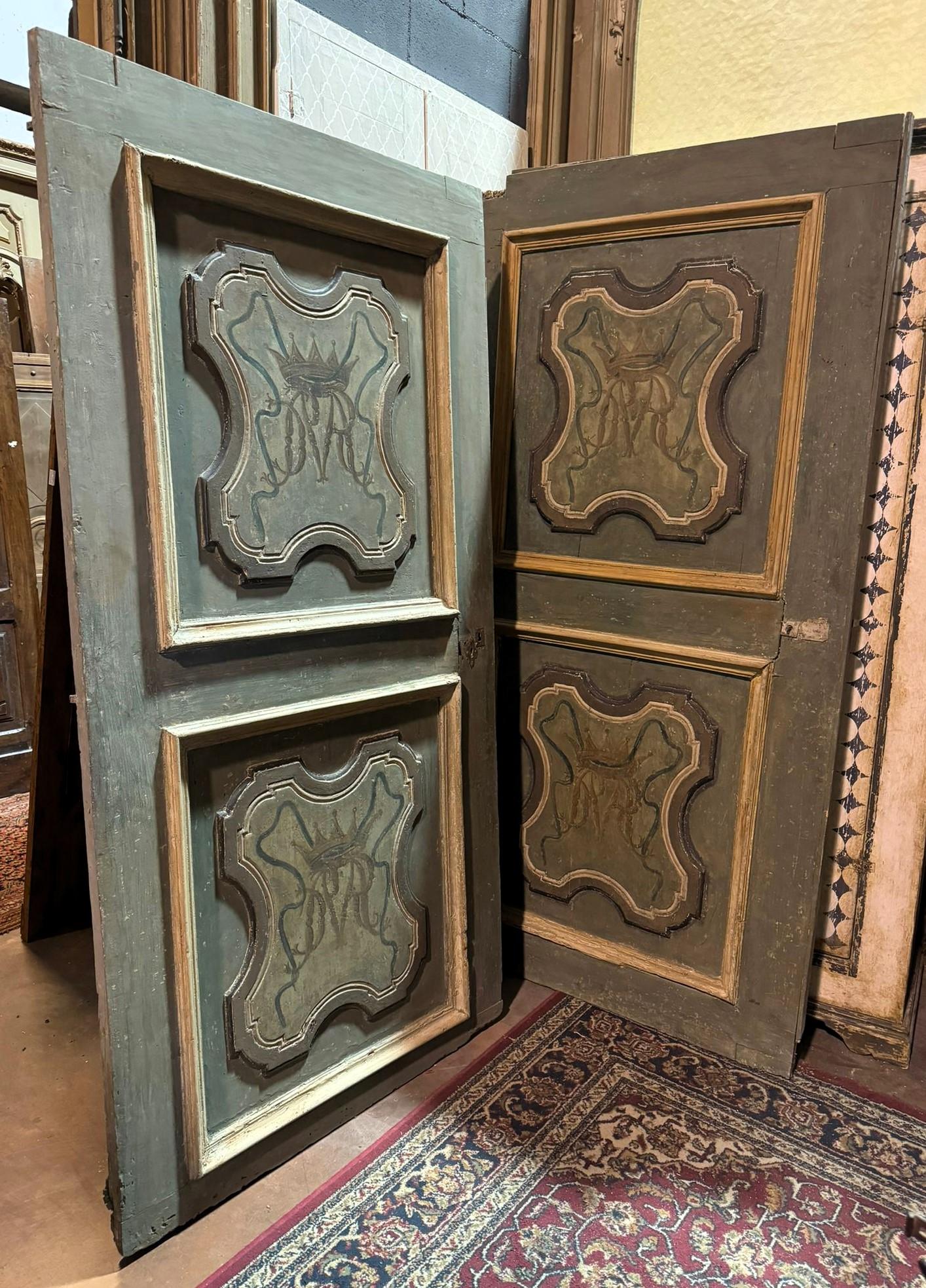 Set of 2antique interior doors, made of painted solid wood, gray green background with decorated noble initials, molded panels and lacquered back. Origin: Italy, carved and painted wavy panels, original from the 18th century.
They each measure w 105