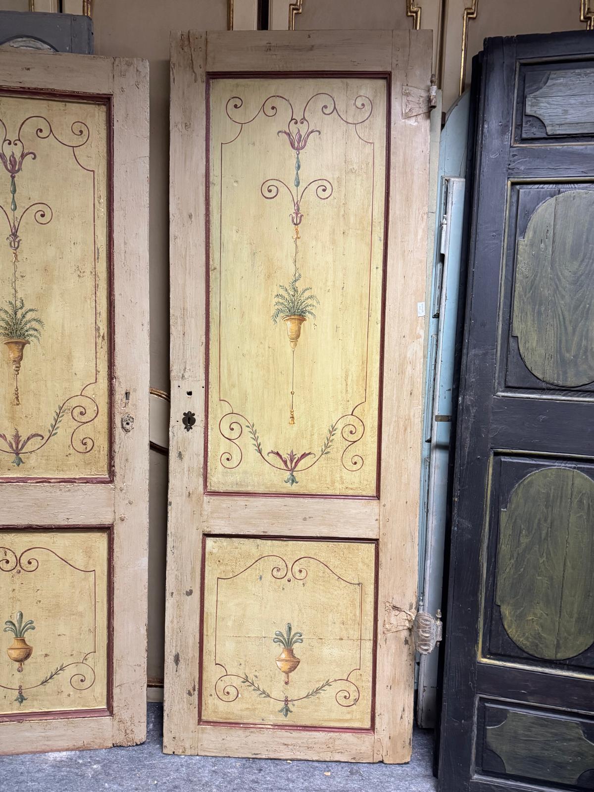 Set of 2 antique painted wooden doors with one leaf and floral decorations, doors composed of two wavy panels with curl decorations and painted flower vase, typical decoration of the period, original from the 18th century. They do not have the