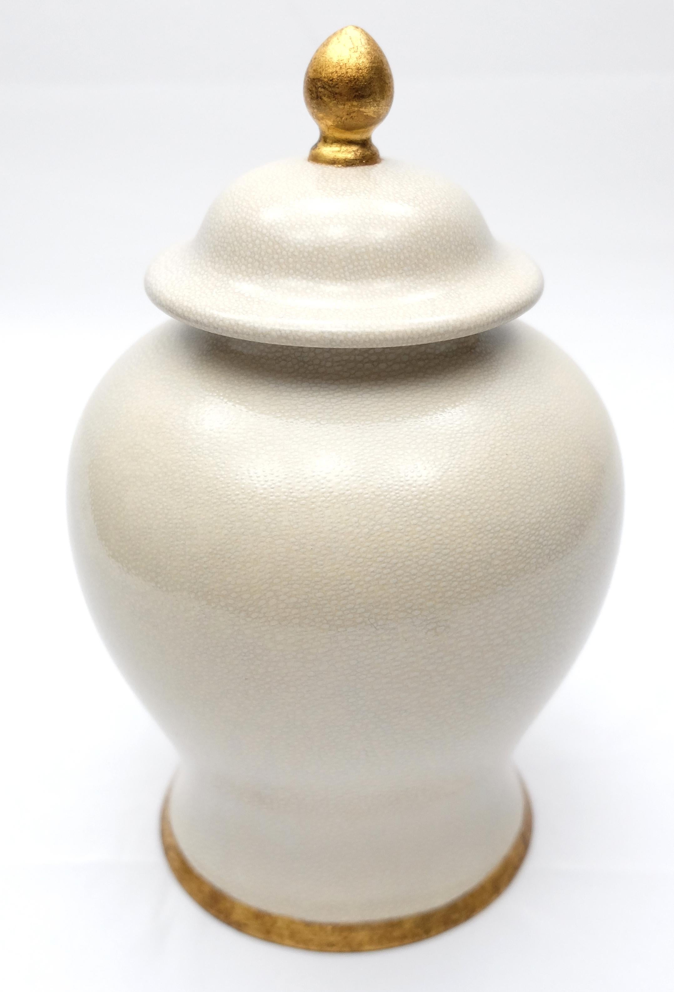 Offered for sale is a set of (2) glazed ceramic lidded ginger jar by Paolo Marioni. The jar has a subtle crazed-glaze finish and is accented in gold-leaf. The jar is signed on the base.