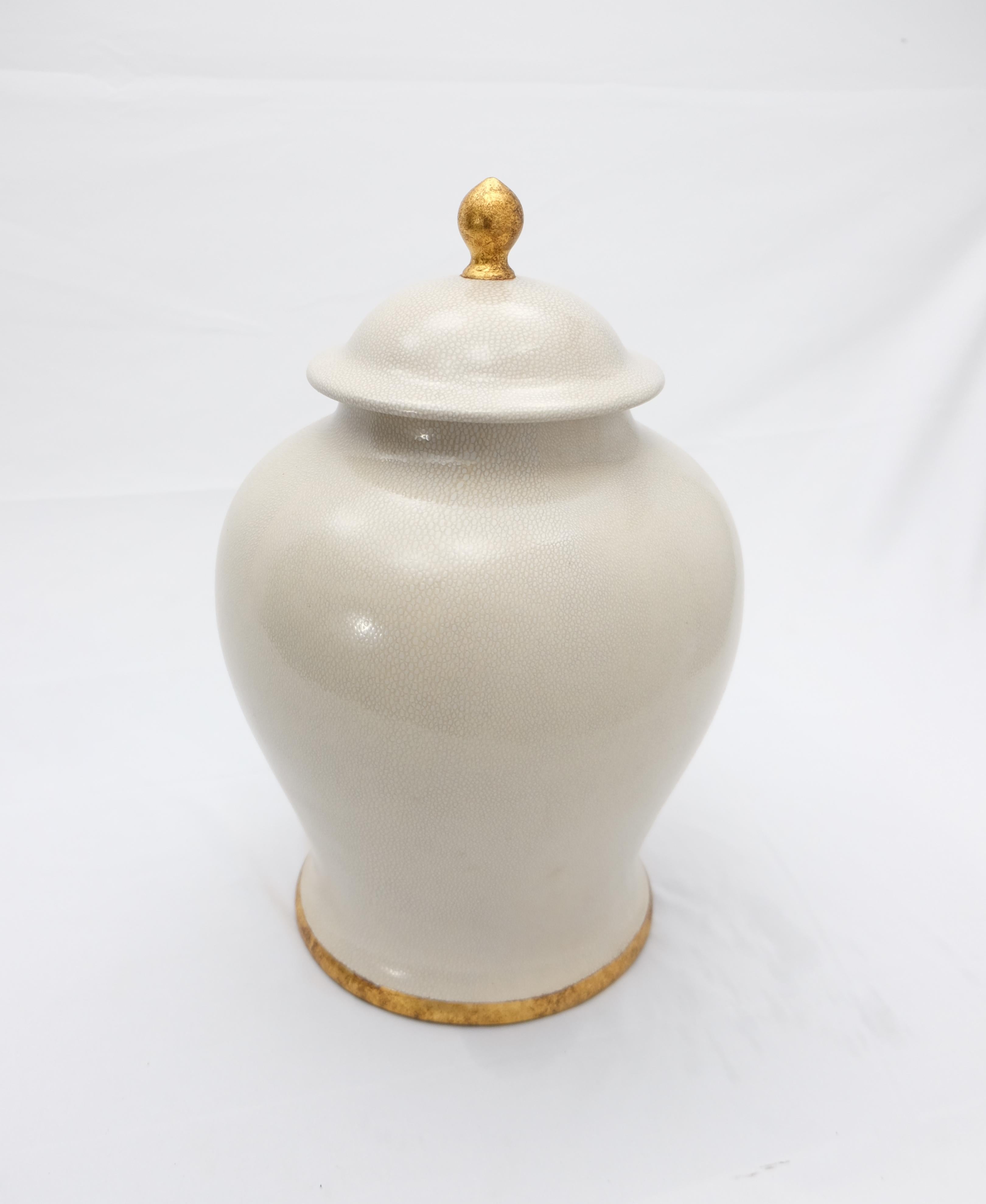 Offered for sale is a large set of (2) glazed ceramic lidded ginger jar by Paolo Marioni. The jar has a subtle crazed-glaze finish and is accented in gold-leaf. The jar is signed on the base.