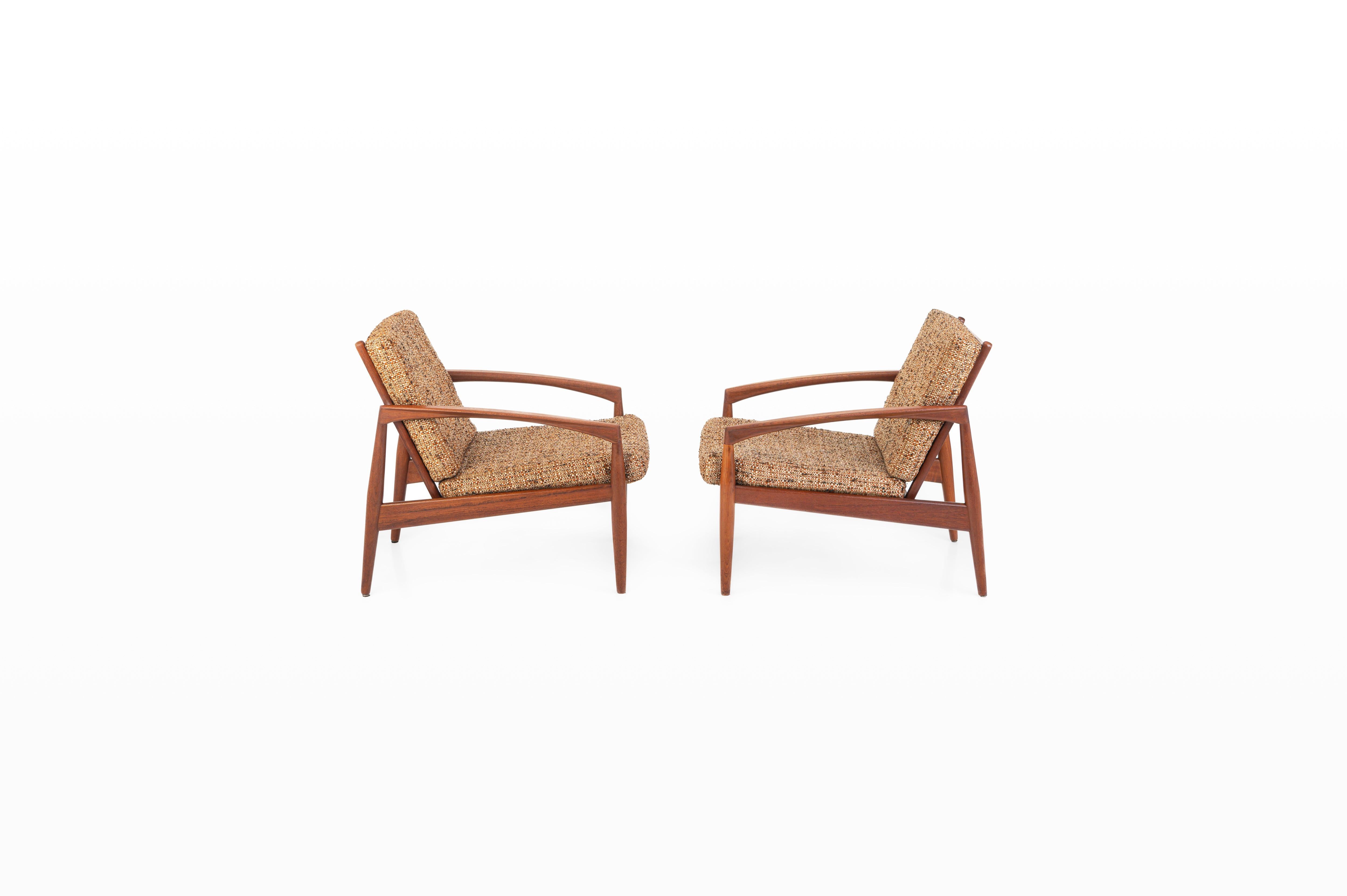 Set of two vintage Paper Knife chairs designed by Kai Kristiansen for Magnus Olesen in Denmark. These easy chairs are designed in 1955. They have a teak frame and a mixed fabric with warm shades of brown, beige and orange.

Dimensions:
W: 64 cm
D:
