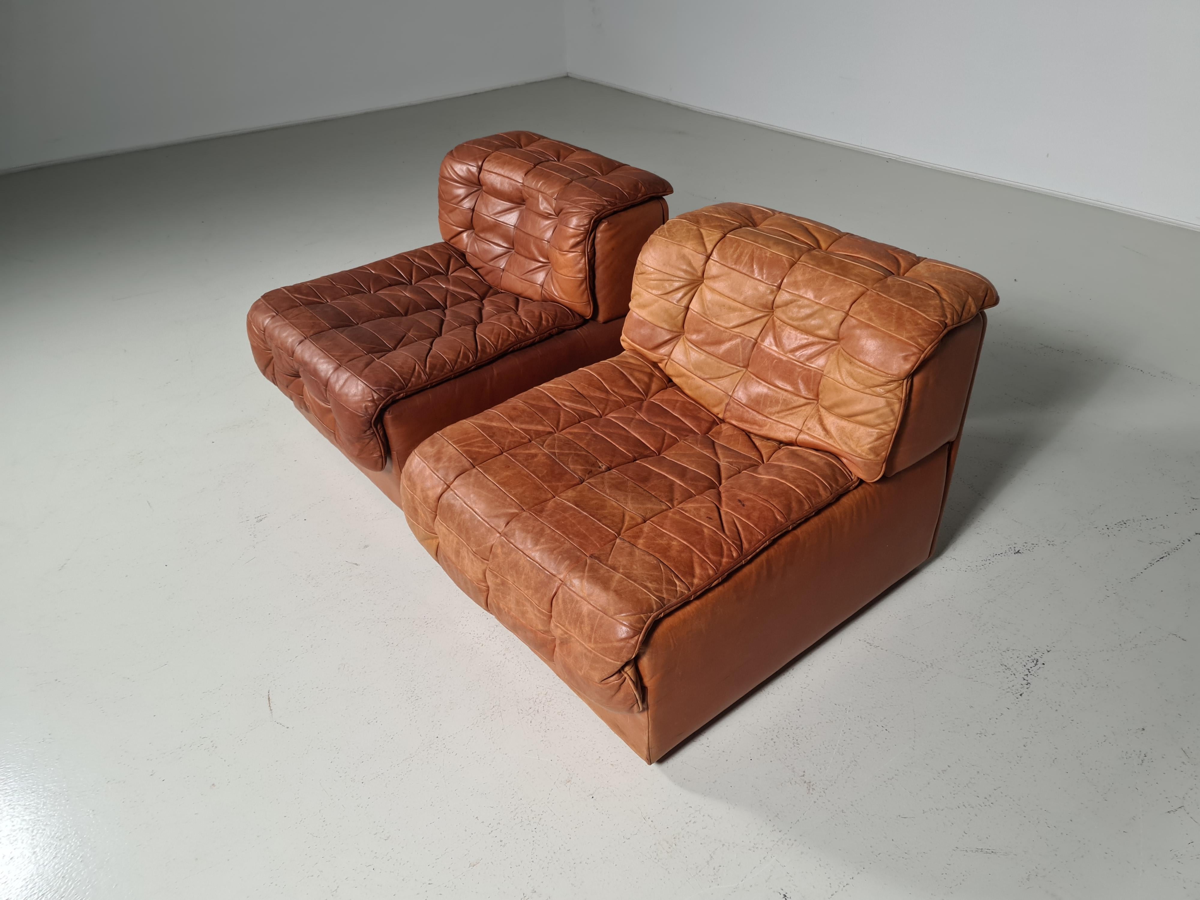 Set of 2 cognac leather patchwork De Sede DS11 chairs, Switzerland, 1970s. The chairs are a bit different in color. Amazing patina.
 