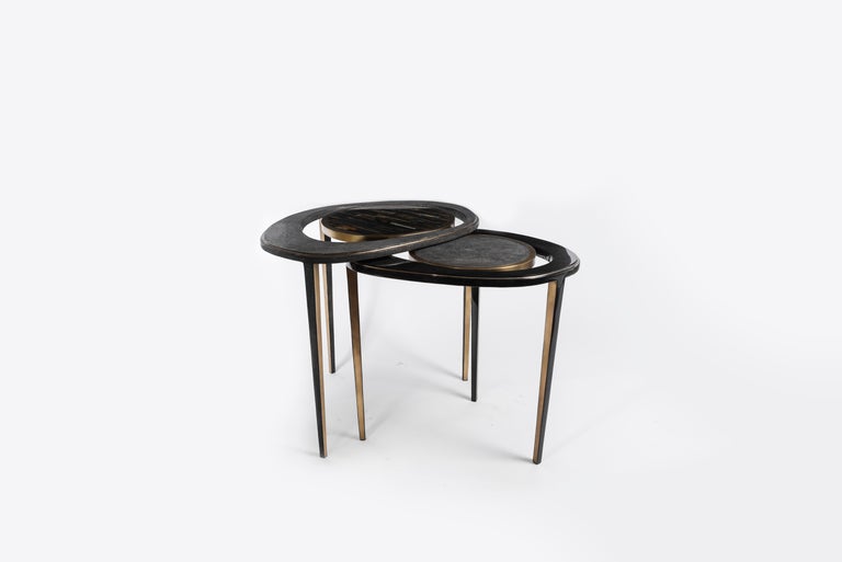 The set of 2 peacock nesting side tables are an iconic R&Y Augousti piece and one of their first designs. The piece is Minimalist and sculptural, with inspiration of course from the shape of exotic peacock feathers. The large piece is inlaid in a