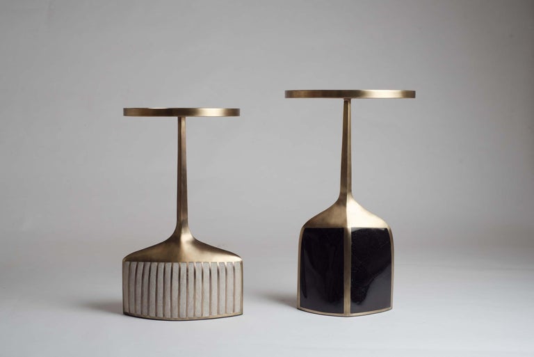 The pedestal side table in small and large are the perfect nesting accent pieces due to their sleek and light aesthetic. The large size is inlaid on the top surface with coal black Shagreen, the bottom part a mixture of black pen shell and bronze