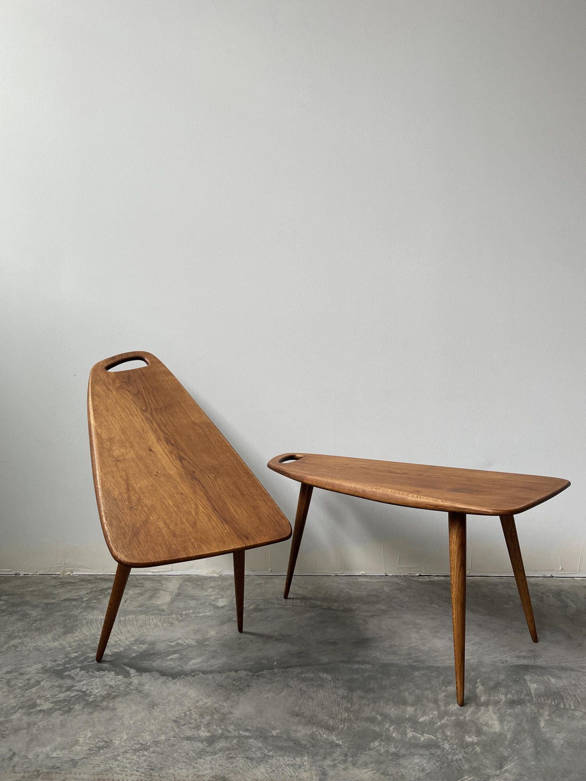 A rare pair of tripod tables in a beautiful free form design featuring a distinct handlebar cutout element reminiscent of a cutting board