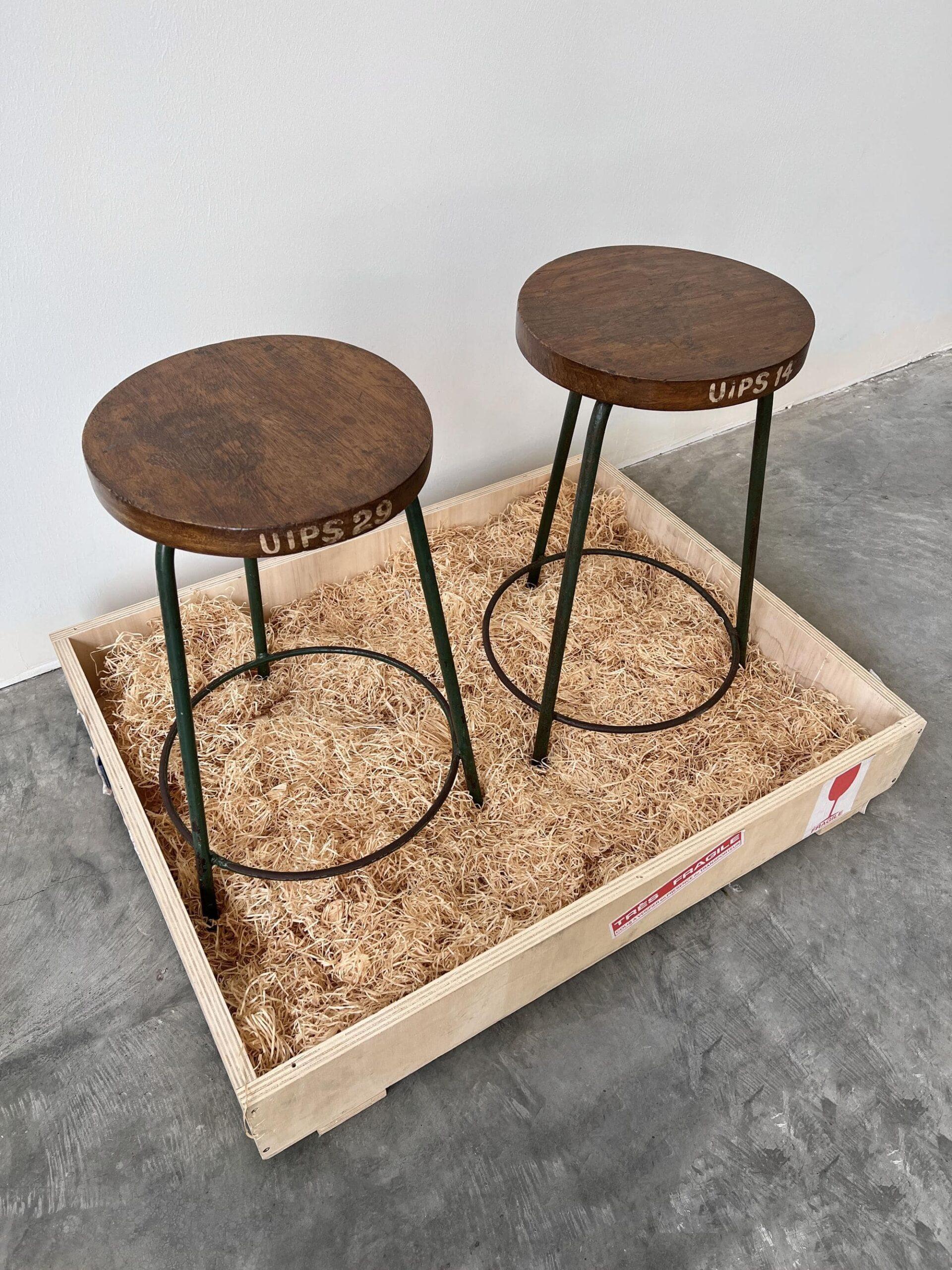 These stools are simple and playful in form but convey an understated elegance. The circular teak seating sits on top of a patinated green color iron tripod base. 

Markings indicate final usage at Institute Of Pharmaceutical Sciences at Panjab