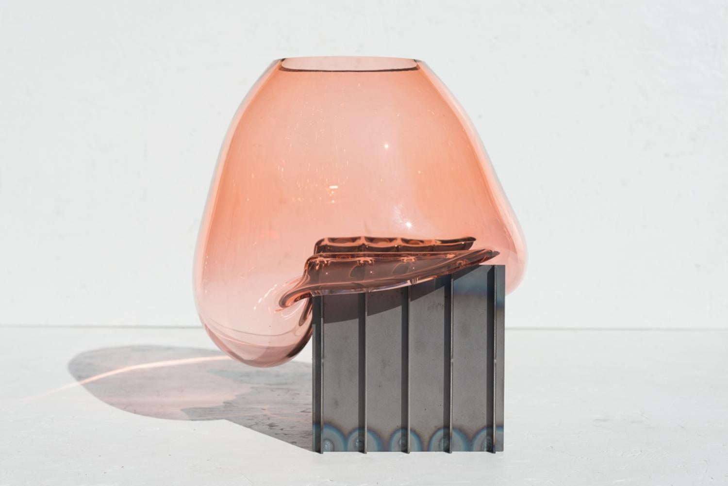 Pink grid table vase by Studio Thier & van Daalen
Dimensions: W 30 x D 35 x H 35cm
Materials: Steel, Glass

The studio was keen to find a way to display the fluidity of glass. Therefore they sought the contrast between the industrial steel and