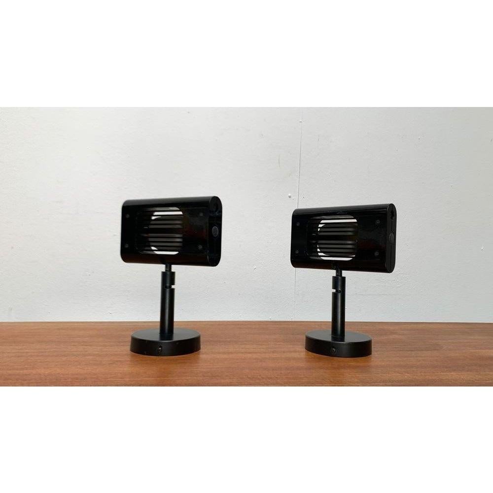 Two rare wall lights from the Italian manufacturer Artemide after a draft by Ernesto Gismondi from the 80s.

The wall lights version from the well -known Aton light series. A technical design. The luminous body is made of metal and kept in black.