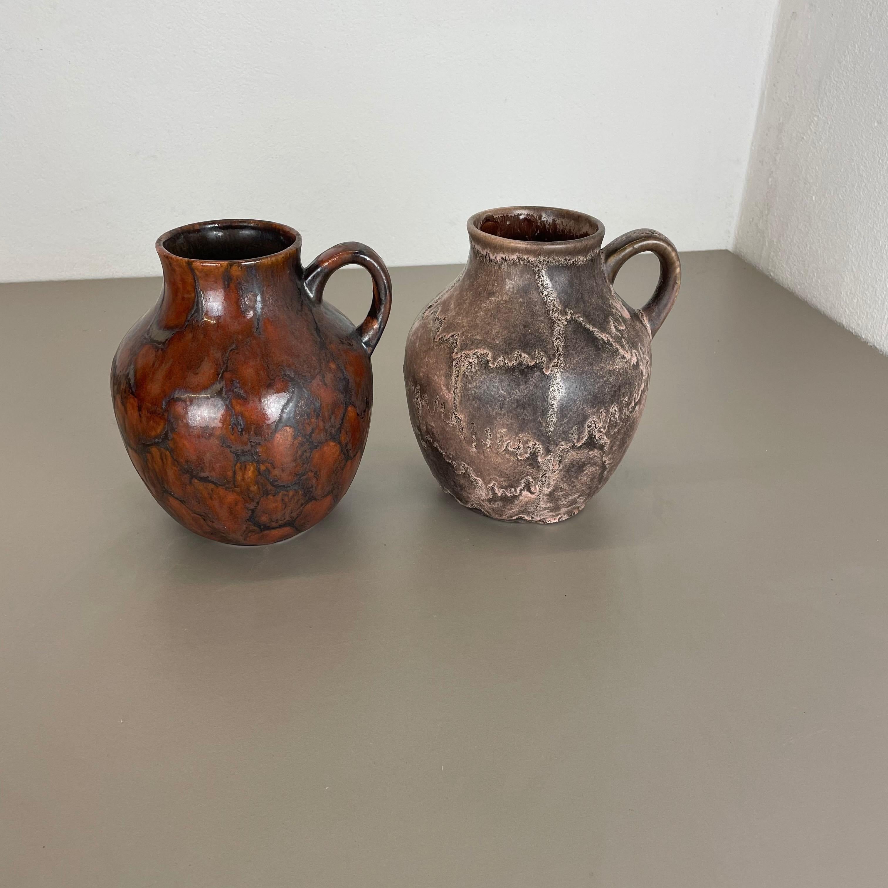 Article:

set of 2 vases


Producer:

Ruscha, Germany



Decade:

1960s


Description:

This original vintage vase set was designed and produced in the 1960s by Ruscha in Germany. This offer contains a set of two multicolor vases