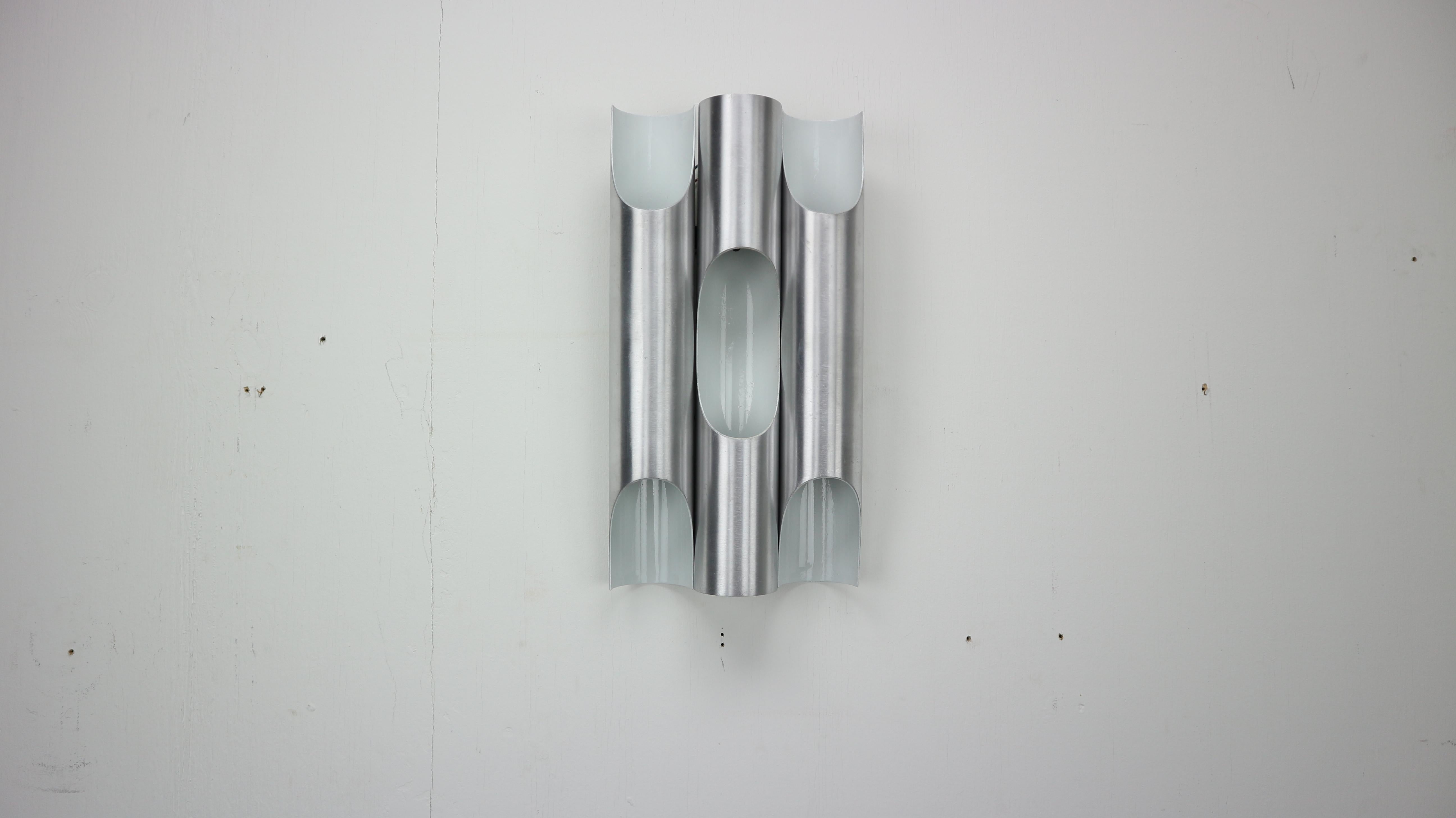 Set of two- RAAK Fuga wall lights by Maija Liisa Komulainen, made in 1960's Netherlands.
A clean pair executed in brushed aluminum and white enamel finish. An incredibly sculptural design inspired by the pipe organs of old European churches.