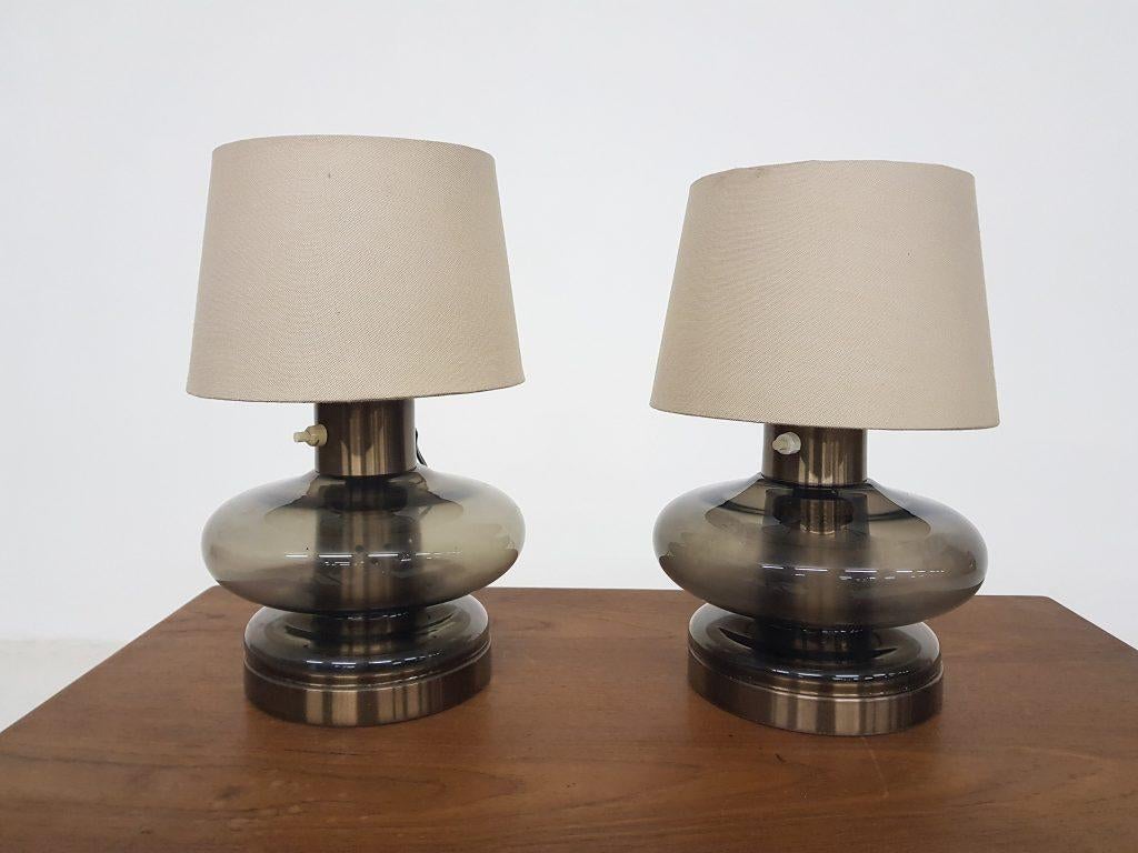 Set of 2 RAAK style glass table lights, the Netherlands, 1960s
Brown glass table lamp with two-light bulbs.
Beige canvas shade (not original).