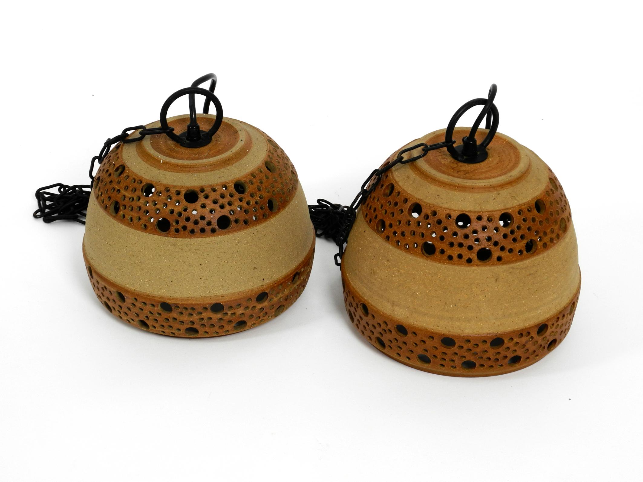 Set of 2 rare and beautiful 1960s ceramic pendant lamps.
Made by the famous ceramic designer P. Bovin, Bornholm. Made in Denmark
Great typical Scandinavian design. Lamp shade is in brown two-tone ceramic.
Great pleasant light. All two lamps are