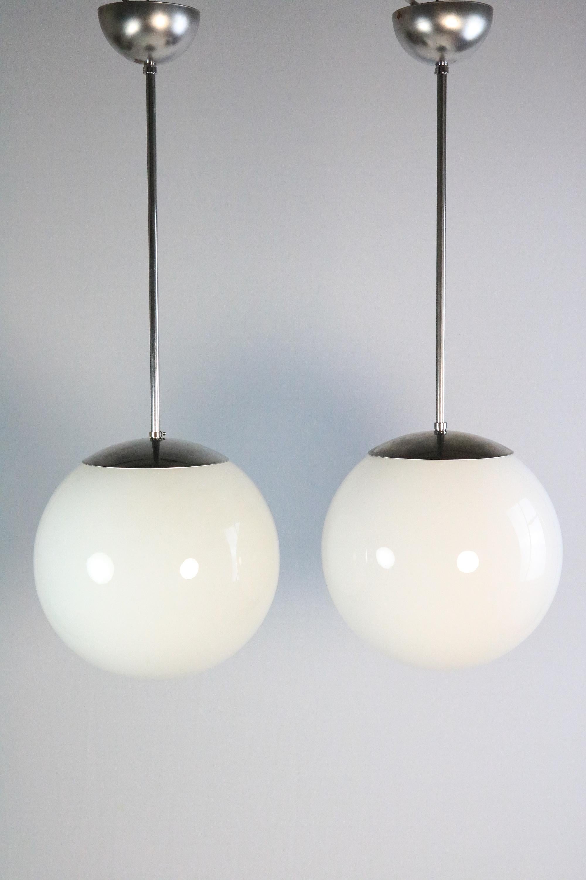 Classic Light from the 1920s 1930s
German ball lamp made of opaline glass.

Set of two lamps. They are minimal different in the size. About 0.2 inches in diameter. You can't see it if you don't know it.
 
All metal parts are new and also rewiring.
