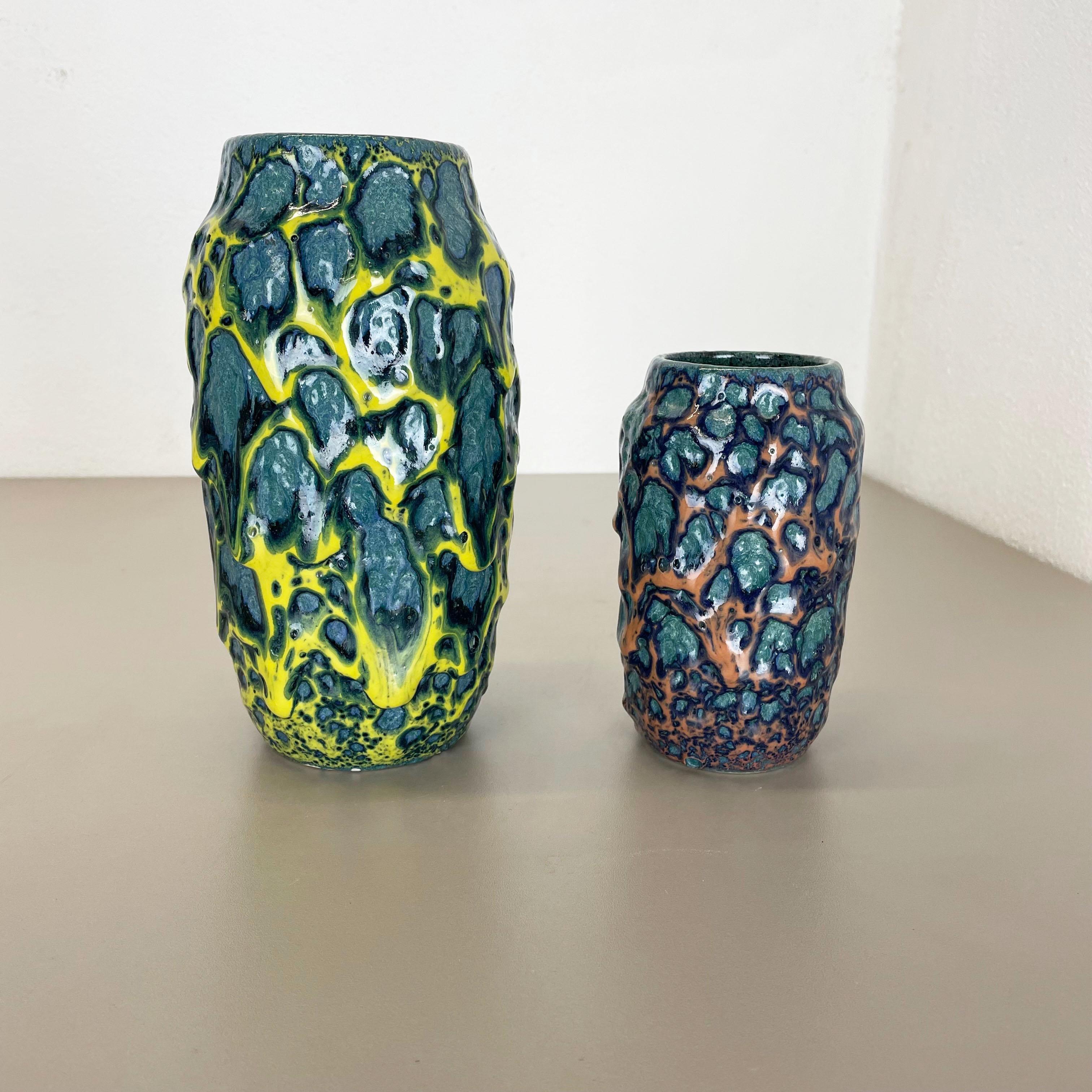 Article:

Fat lava art vase, heavy Brutalist glaze  set of 2


Producer:

Scheurich, Germany



Decade:

1970s




This original vintage vase set was produced in the 1970s in Germany. It is made of ceramic pottery in fat lava optic with abstract