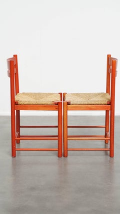 Set of 2 red vintage wooden chairs from the 1970s with a woven wicker seat