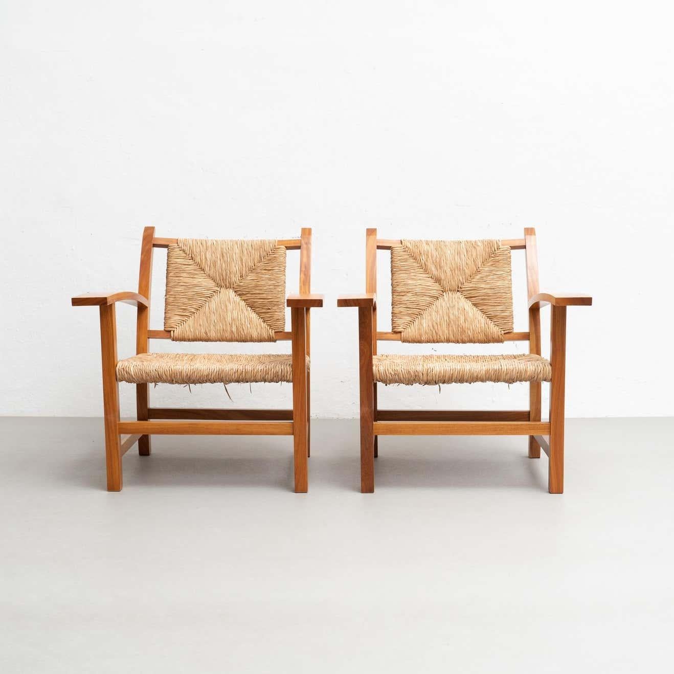 Set of two reedited armchairs after Josep Torres Clave.

Manufactured in Spain, circa 1987.

Materials:
Wood and rattan

In great original condition, with minor wear consistent with age and use, preserving a beautiful patina.


