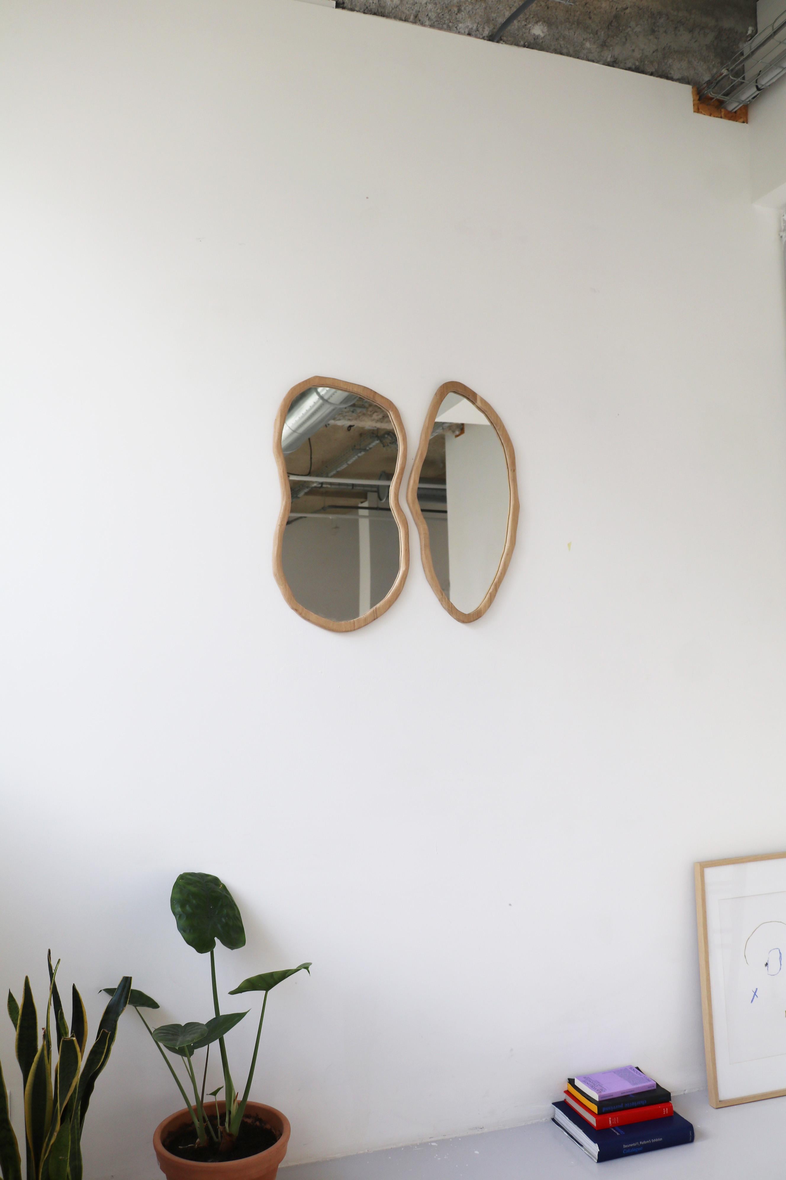 Set of 2 Rencontre large mirrors by Alice Lahana Studio
Cut with a chisel, each model is unique.
Dimensions: 
Left: 60 H x 45 cm
Right: 60 H x 37 cm
Materials: French Oak.

The Rencontre mirror duo is handmade in Paris.
The mirrors can be