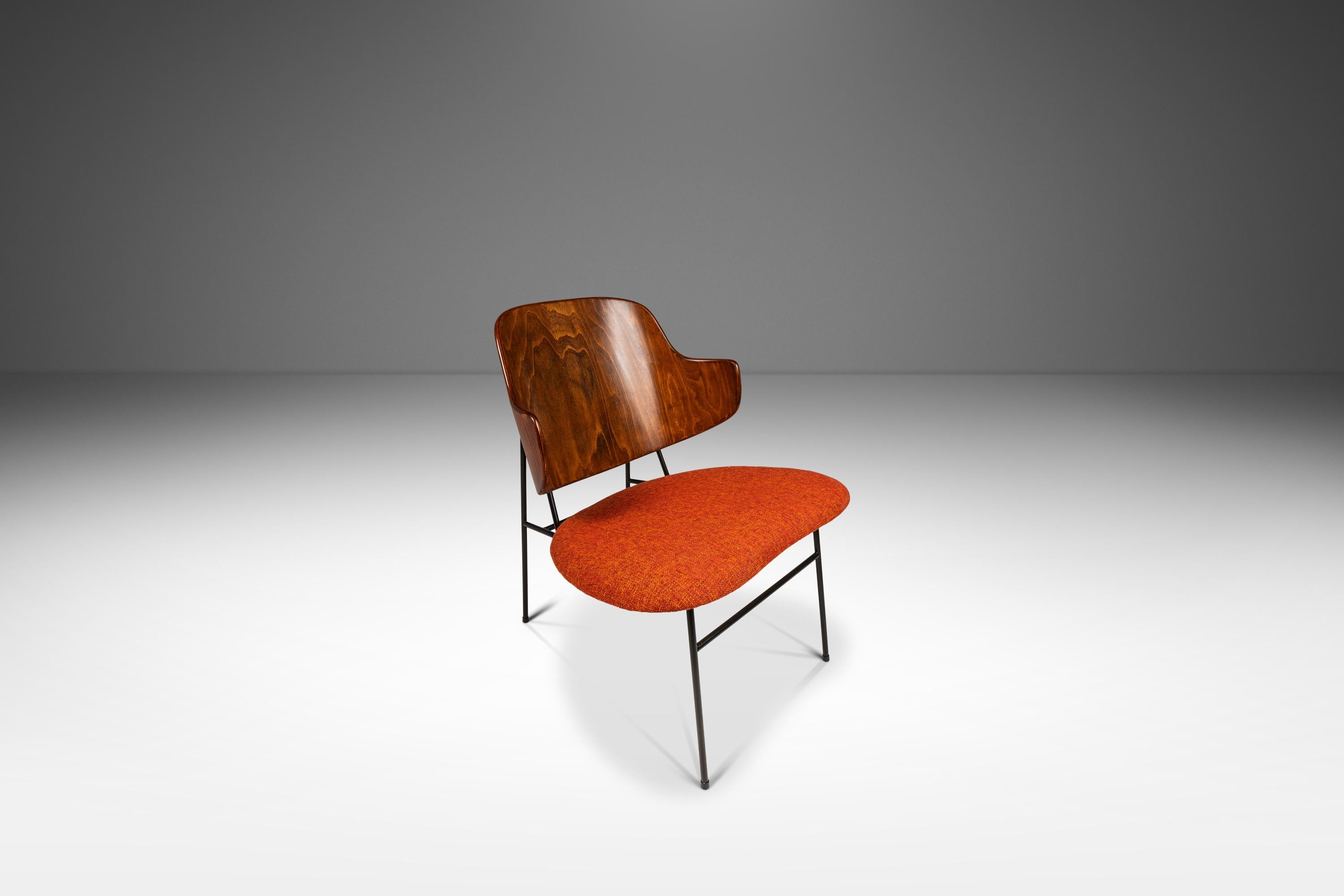 Introducing a rare set of authentic 'Penguin' chairs designed by Ib Kofod-Larsen for Selig.  First produced by Selig in 1953 these now iconic Danish Modern chairs are the epitome of Danish Modern Design. Featuring a plywood molded back, a thin metal