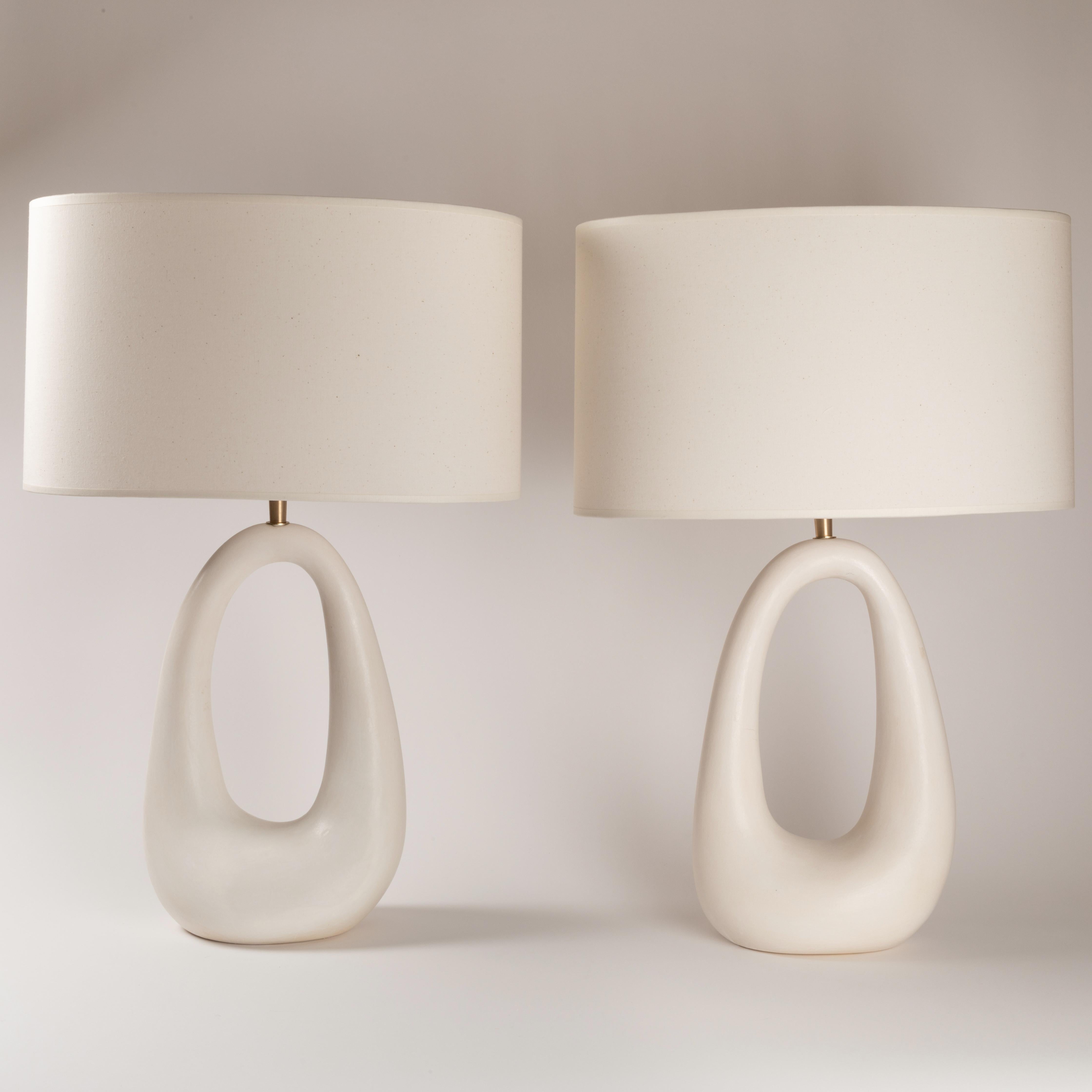 Set of 2 ring table lamps by Elsa Foulon.
Dimensions: D 64 x H 41 cm.
Materials: ceramic, brass, linen.
Unique piece
Also available in different finishes and dimensions.

All our lamps can be wired according to each country. If sold to the USA