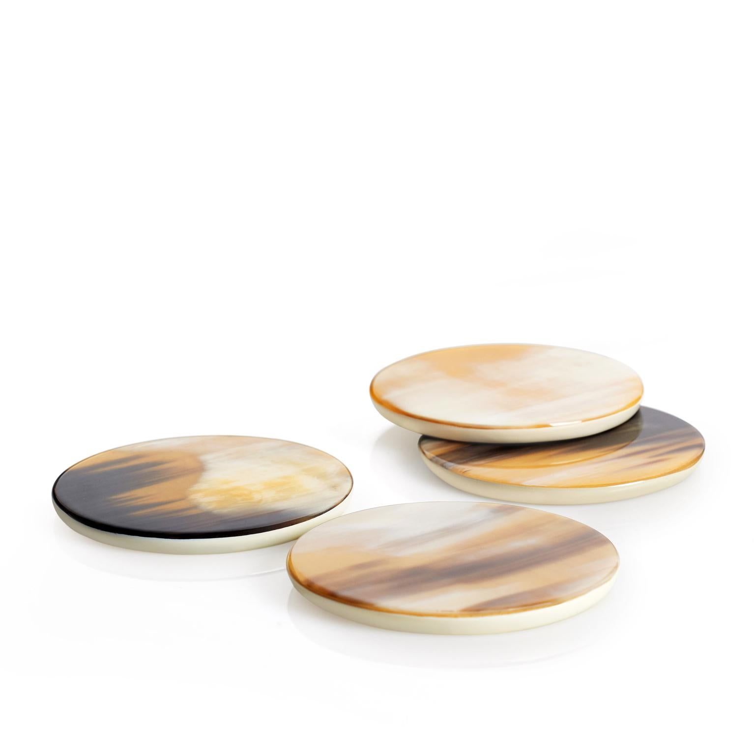 Playing a funtional yet decorative role, these round coasters are a clever blend of exclusive materials and gentle shapes. Handcrafted from lacquered wood with cream-colored finish, each coaster's top showcases the signature patterns and the unique