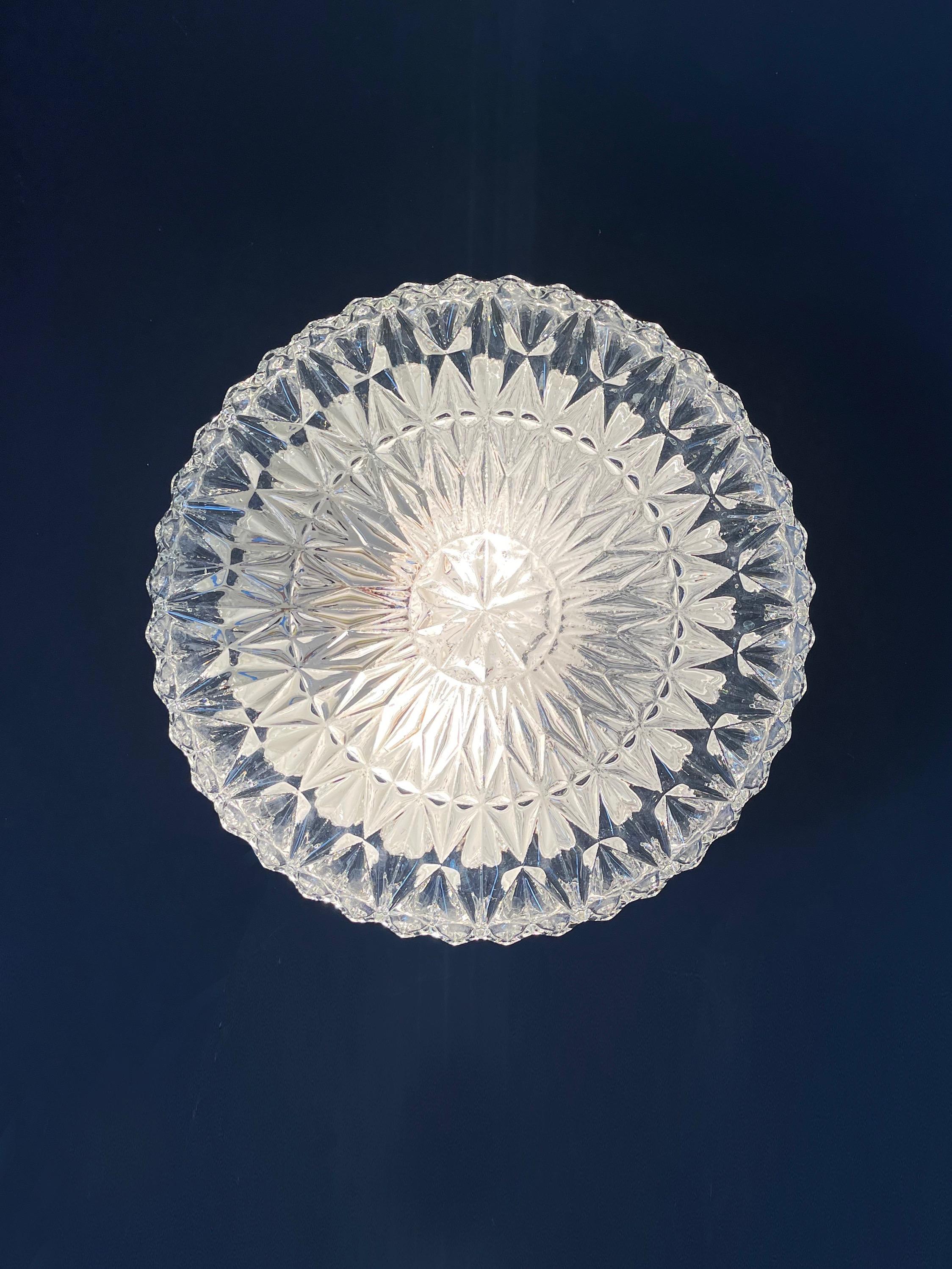 A beautiful set of 2 medium sized flush mount wall- or ceiling lamps by Honsel Leuchten, Germany. 
German classic of the 1960s to 70s.
The light shades are from chunky, ice crystal shaped colourless glass
Gorgeously textured 3D glass, flush mount