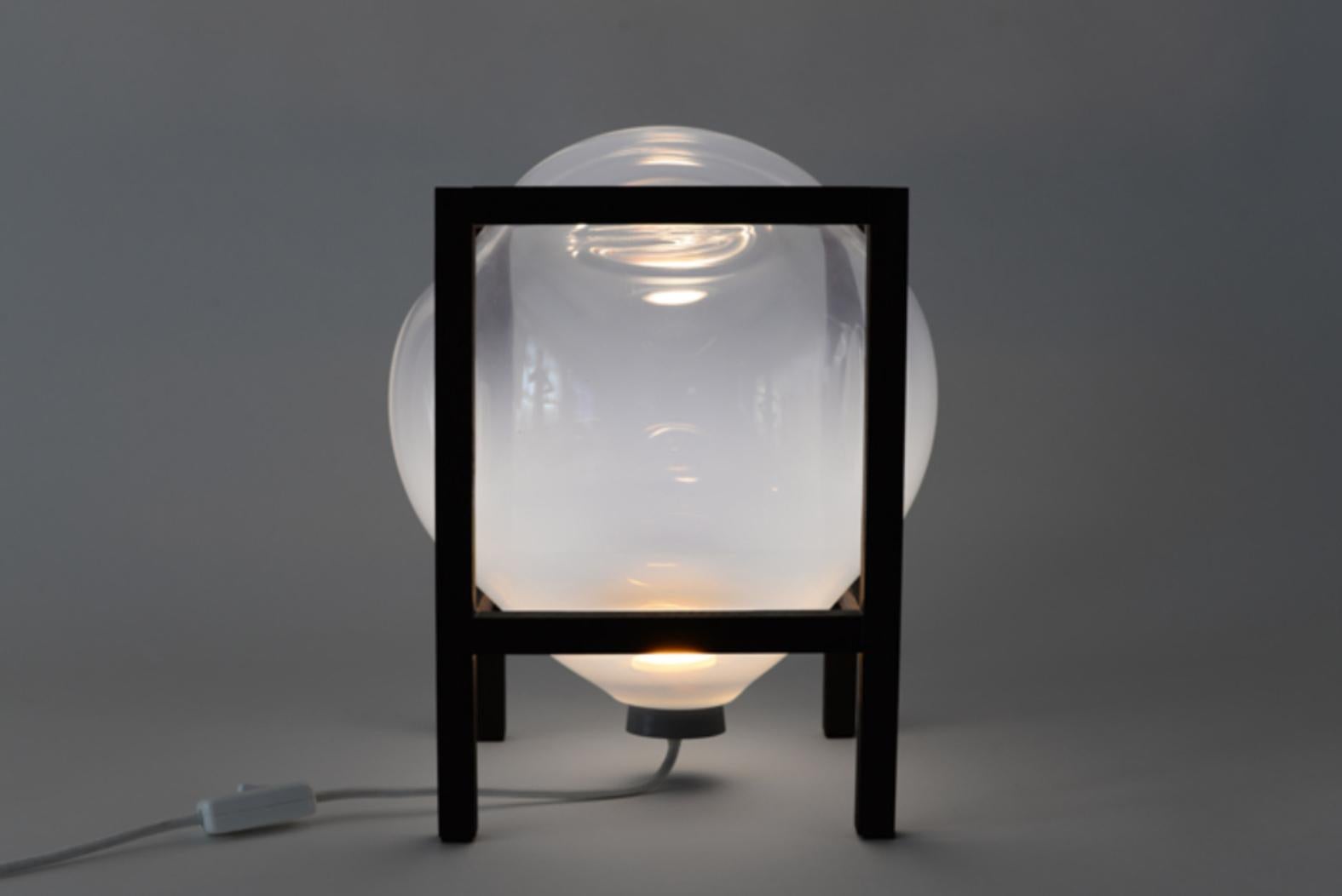 Set of 2 round square white balloon table light by Studio Thier & van Daalen
Dimensions: W 24 x D 24 x H 38 cm
Materials: Wood, Glass

When blowing soap bubbles in the air Iris & Ruben had the dream to capture these temporary beauties in a