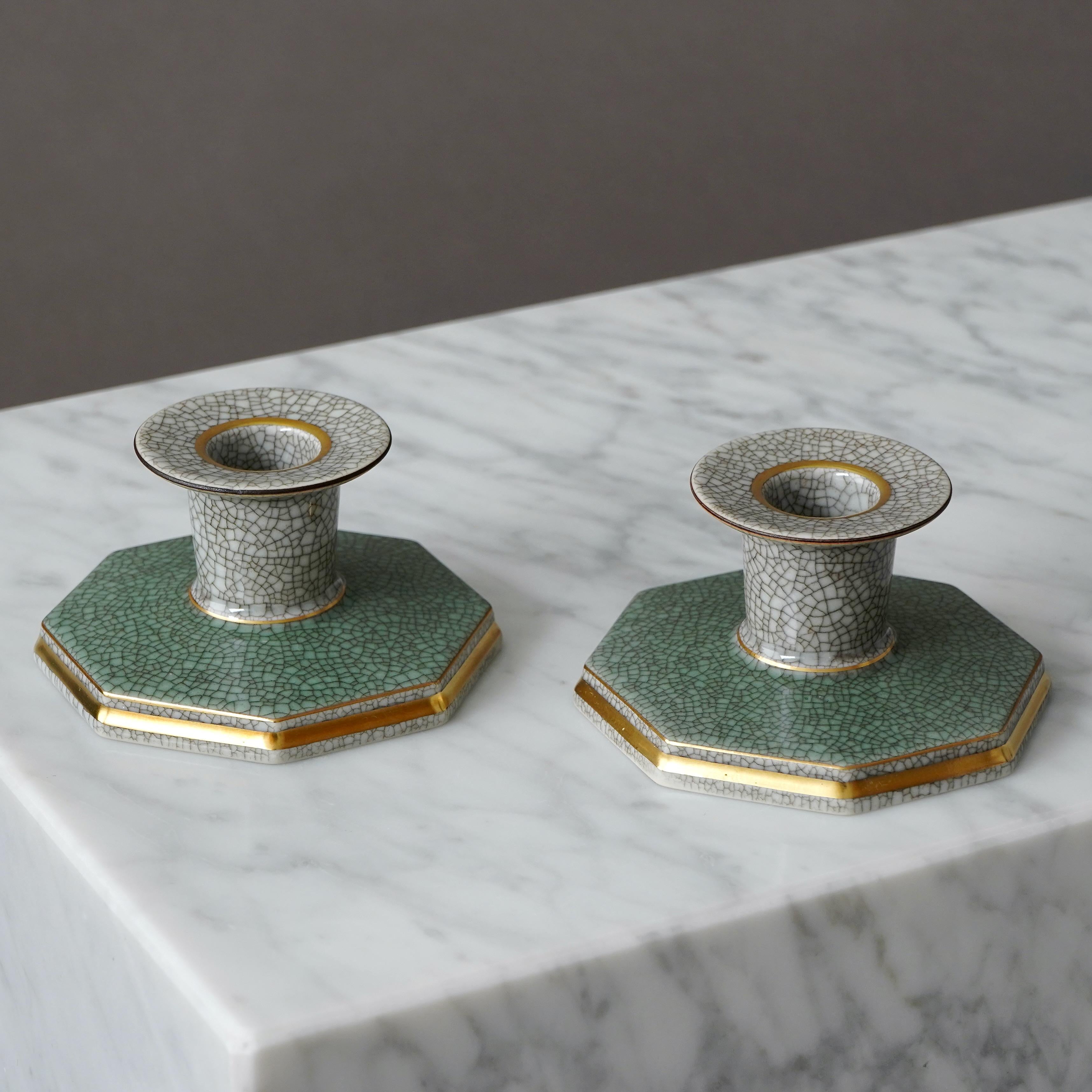 Elegant Royal Copenhagen crackle glazed candlesticks with gilded banding on the rim and base.
Designed by THORKILD OLSEN (1890-1973) for ROYAL COPENHAGEN. Made in Denmark, 1957.

Great condition. Factory second (for no obvious reason). 
Makers marks