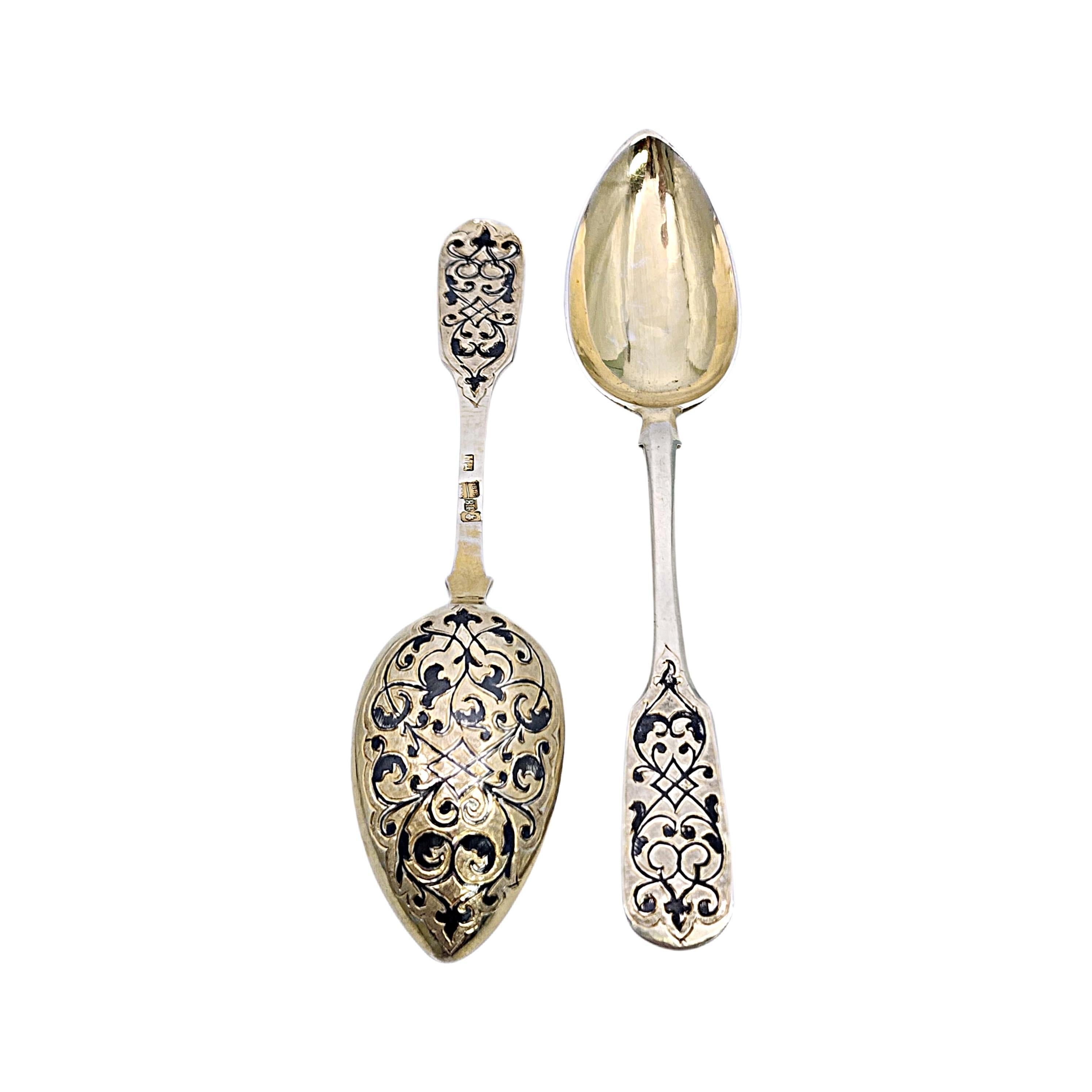 Set of 2 Russian Imperial silver gold wash and enamel spoons.

A pair of Russian spoons made of 84 zolotnik silver, which is .875 purity. They feature pointed gold wash bowls with an intricate enamel design on the back of the bowls with a matching