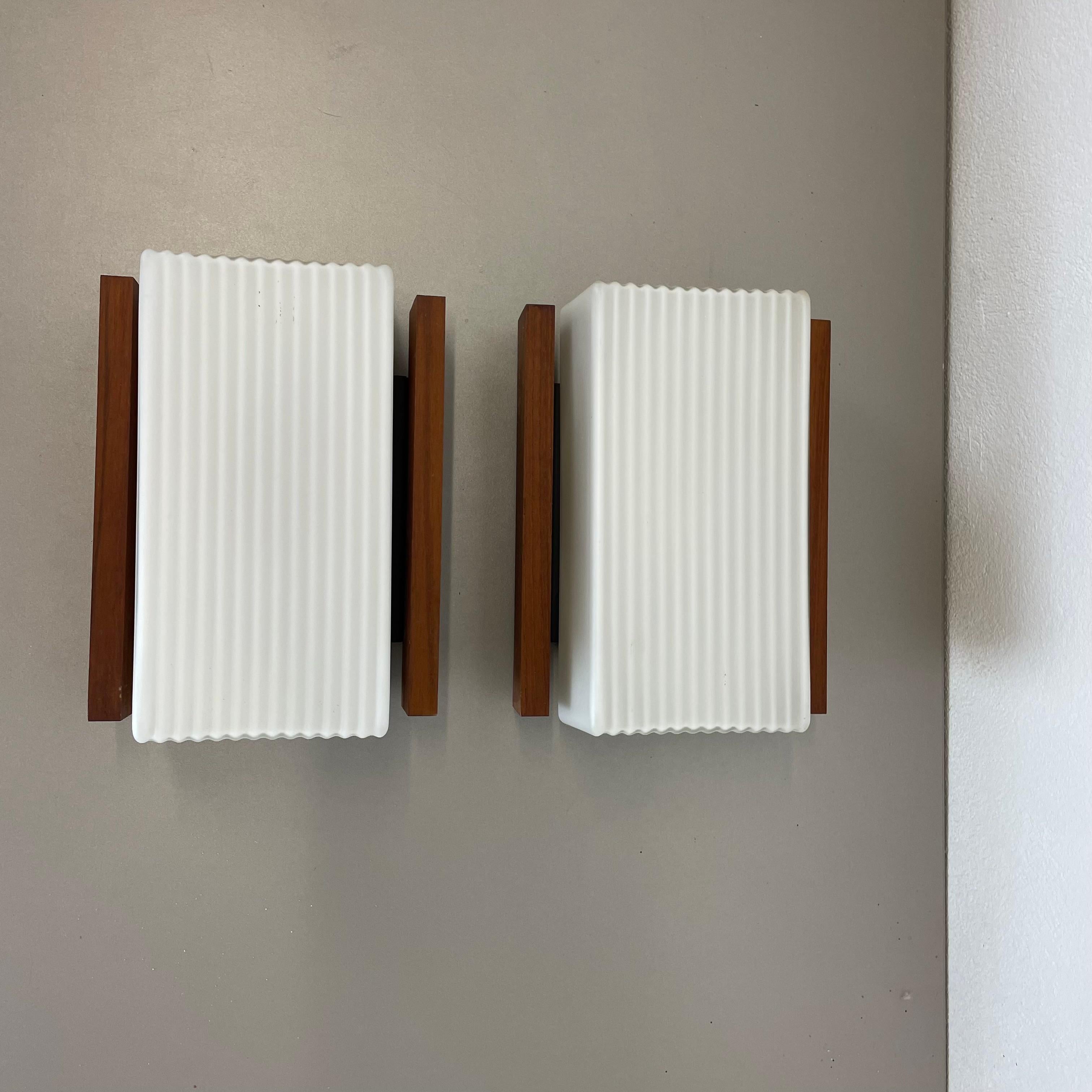 Mid-Century Modern Set of 2 satin white glass and teak Wall Lights by BEGA Lights, Germany 1960s For Sale